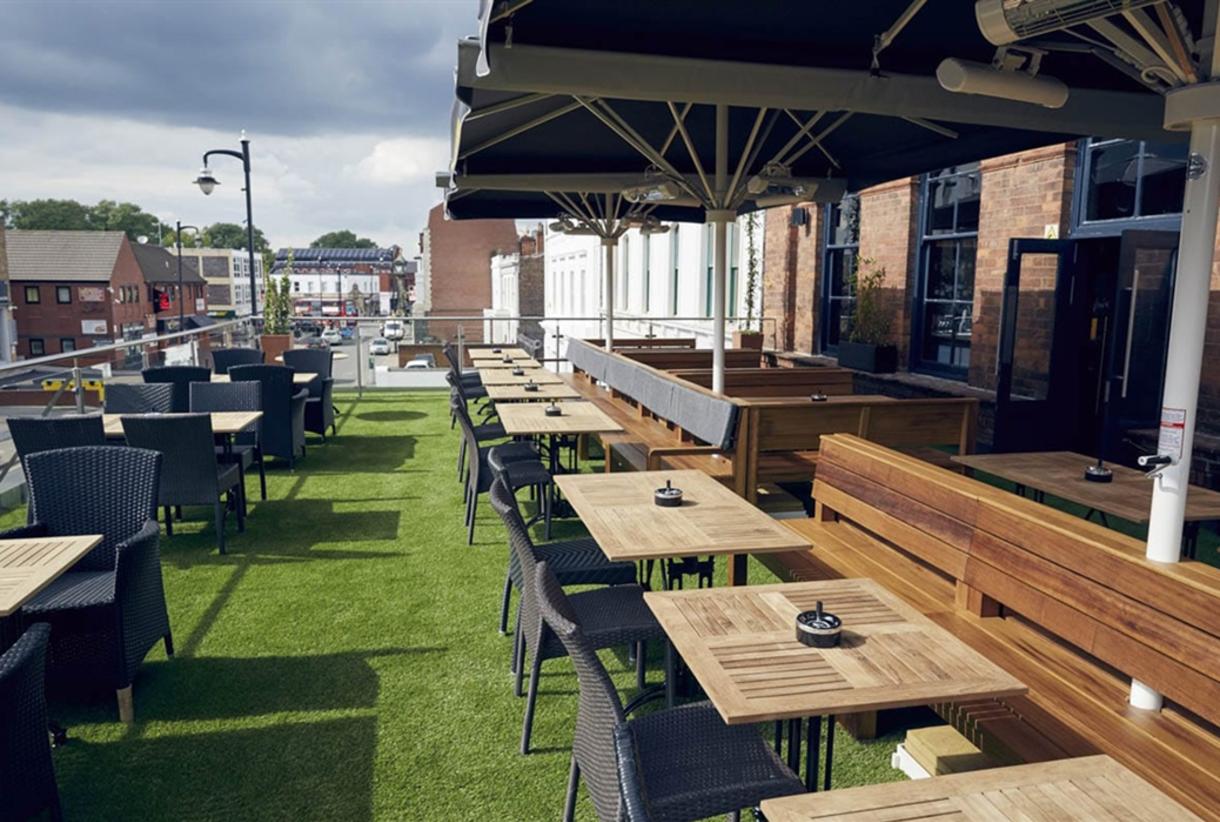 Stylish outdoor venue at The Button Factory with green turf for casual events and networking.