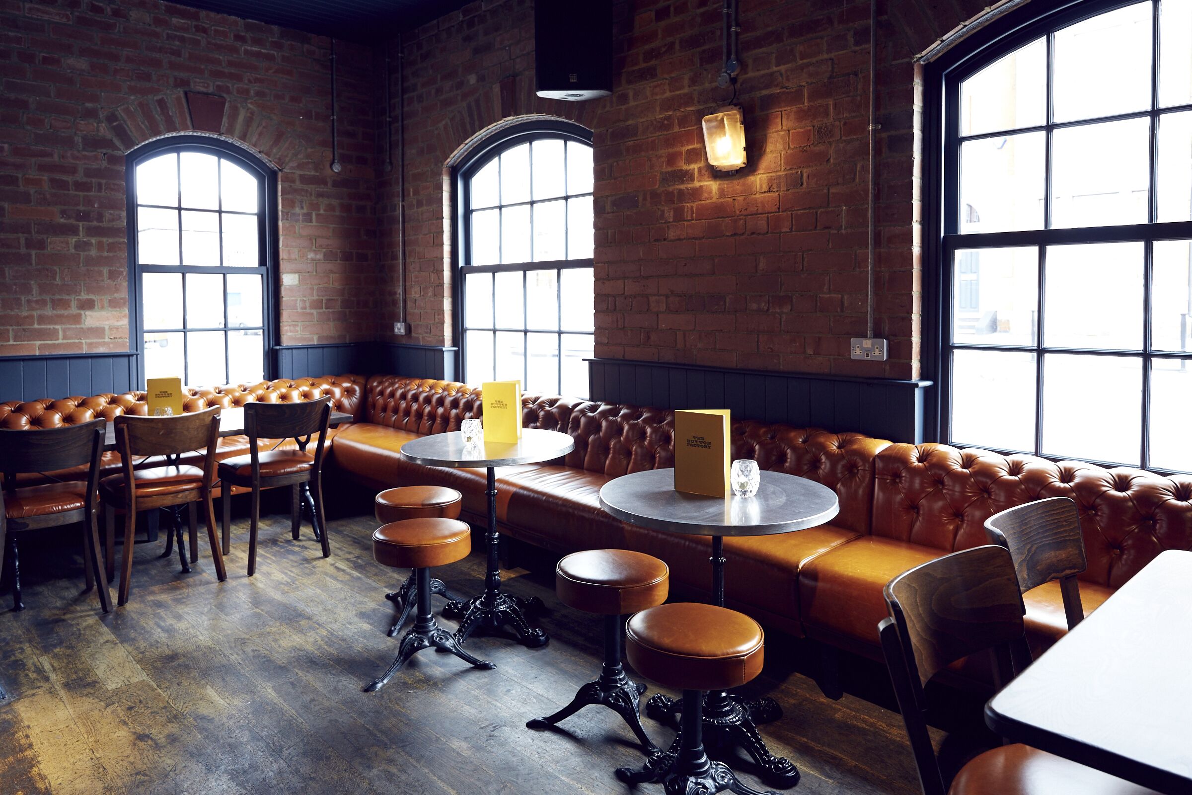 Stylish Button Factory venue with leather seating, ideal for gatherings and meetings.