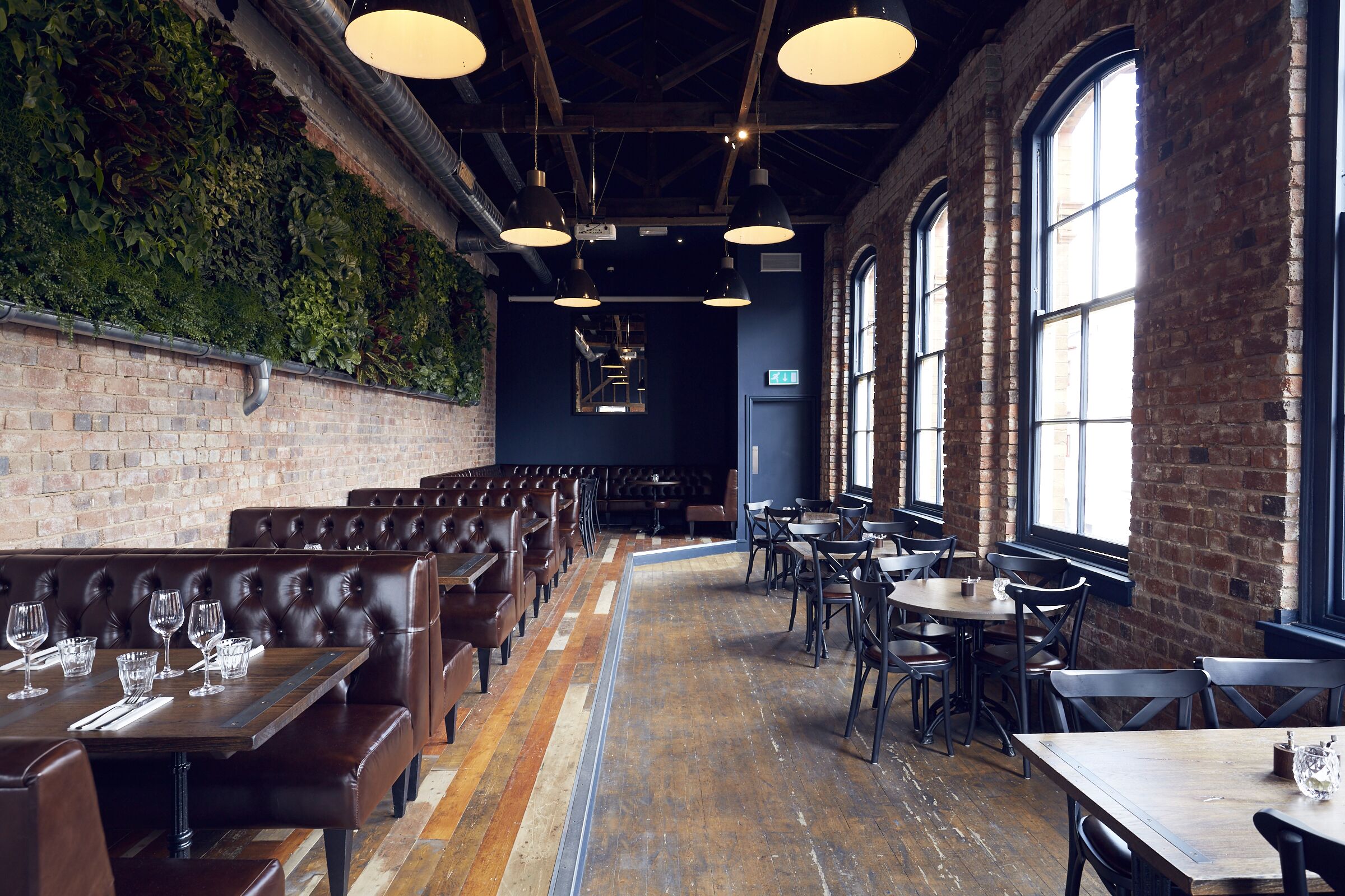 Stylish Upstairs Bar with exposed brick, perfect for networking events and private dinners.