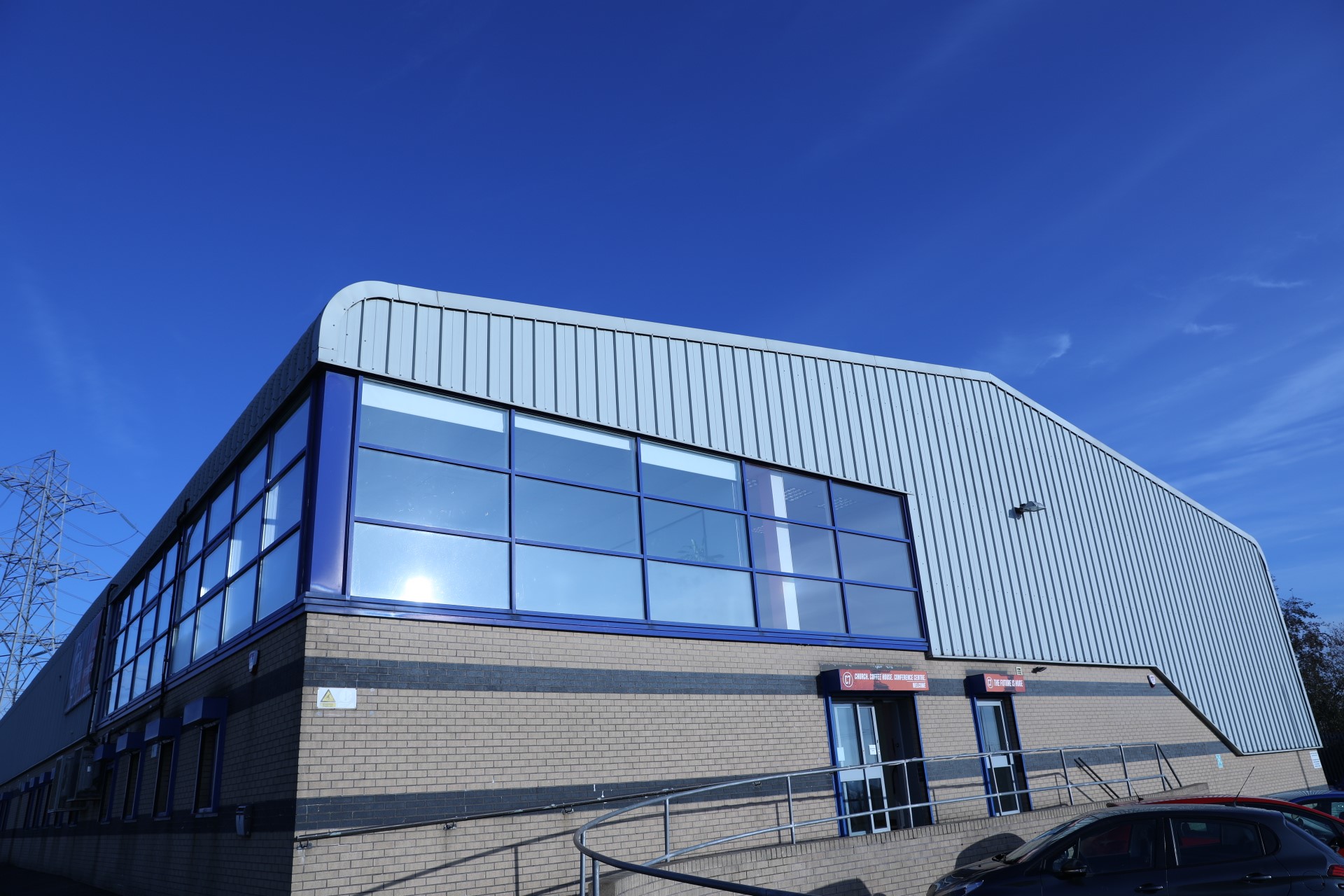 Modern auditorium with large windows, perfect for corporate events and exhibitions.