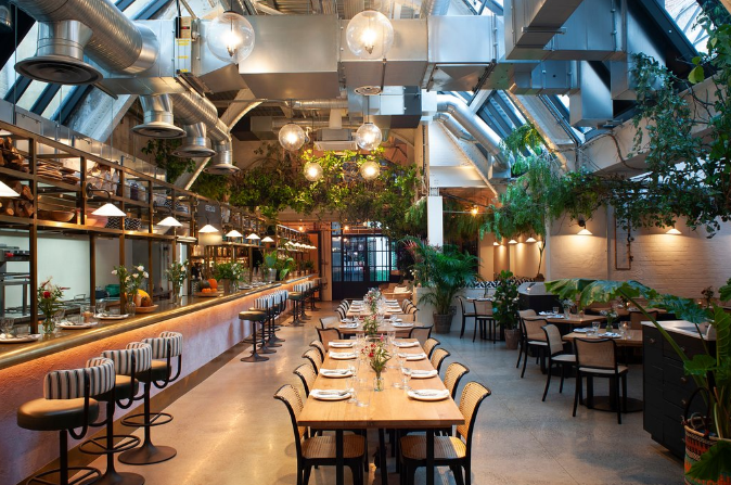 Modern venue with greenery for events at Wild by Tart, ideal for gatherings and meetings.
