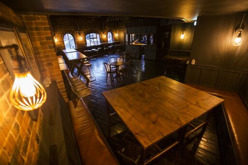 Gin Parlour event space in The Distillery Birmingham, rustic decor for gatherings.