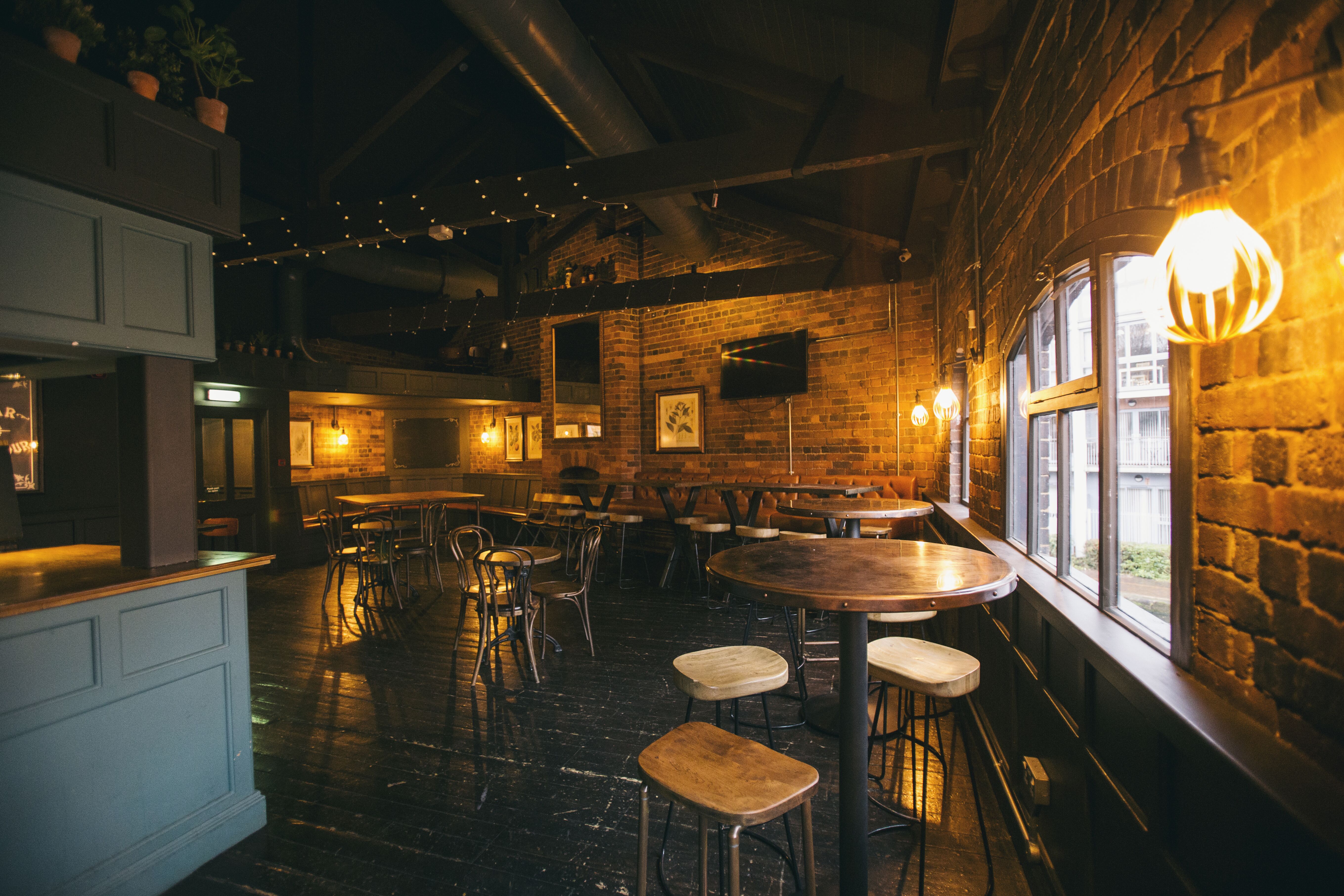 Gin Parlour event space in The Distillery, Birmingham with exposed brick walls for gatherings.