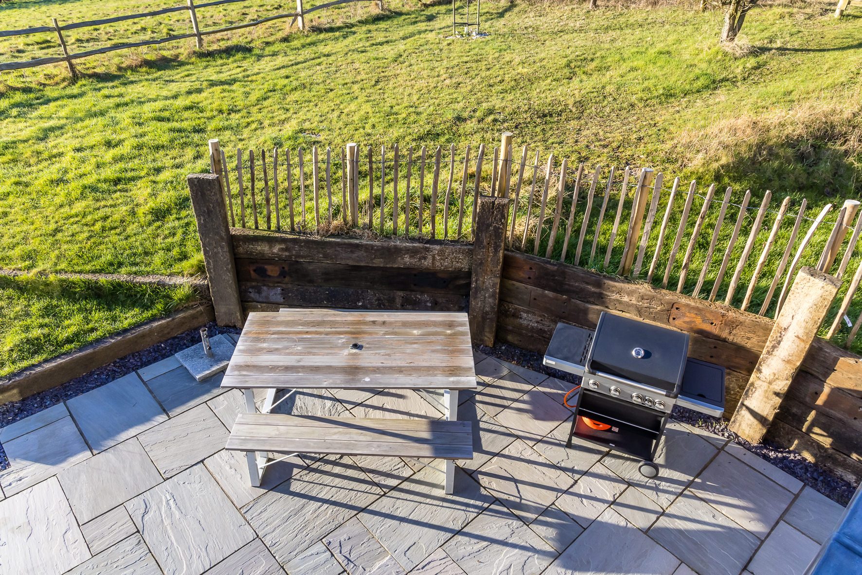Outdoor event space at The Grain Store Lewes with rustic picnic table for summer barbecues.