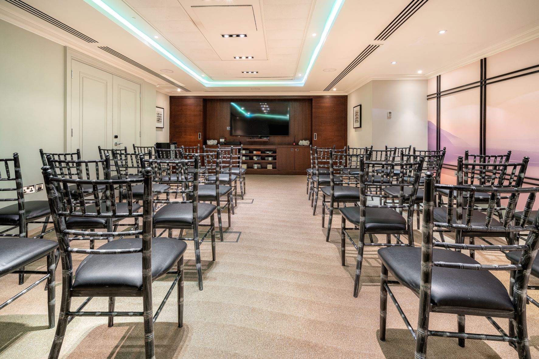 The Prince Room at The Prince Akatoki London, modern seminar space with black chairs.