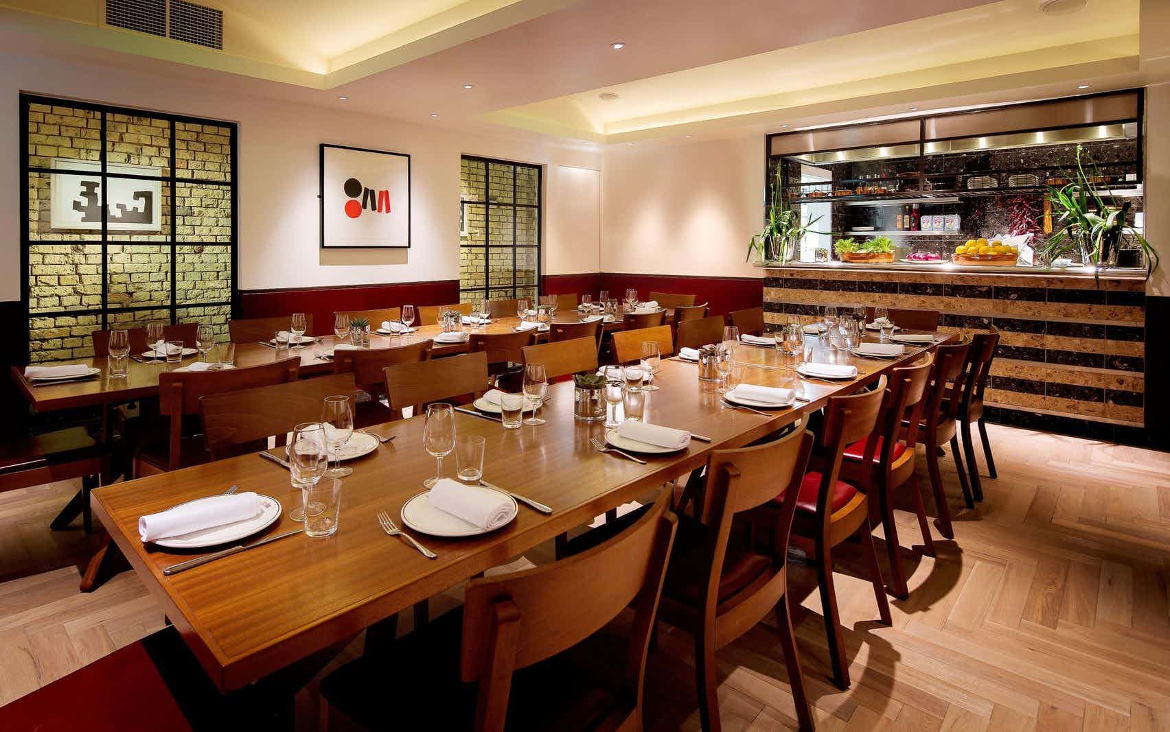 Private dining room with wooden table, ideal for networking dinners and intimate events.