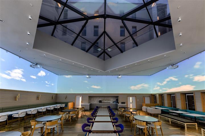 Imaginex 360° Screening room, modern event space with glass ceiling for workshops and networking.