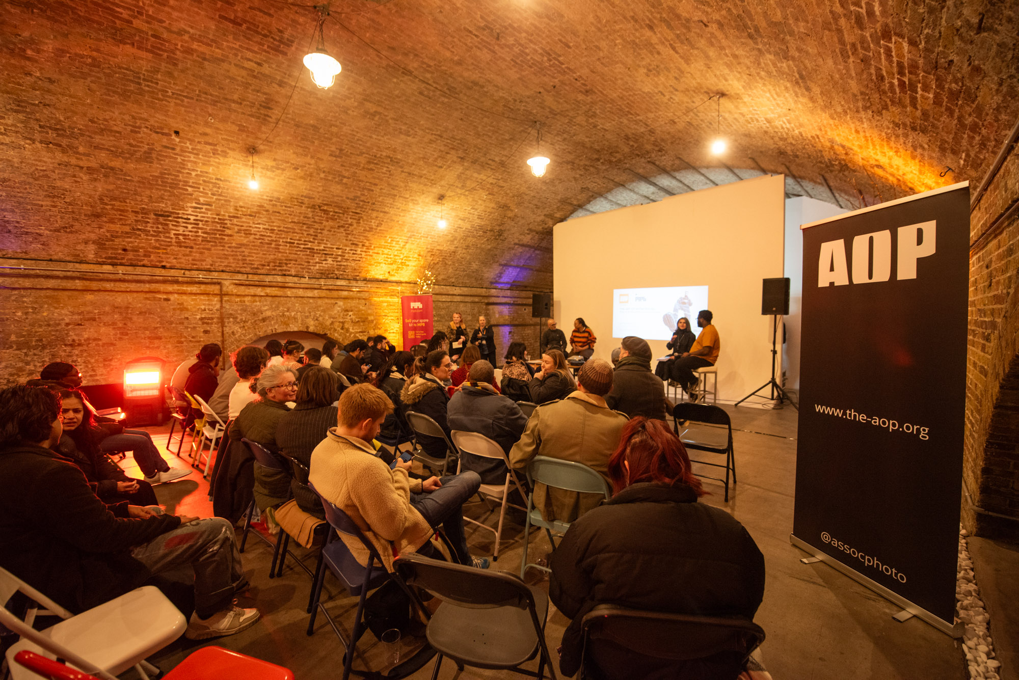"Engaged audience in Studio 1 at MOTEL for a professional panel discussion event."