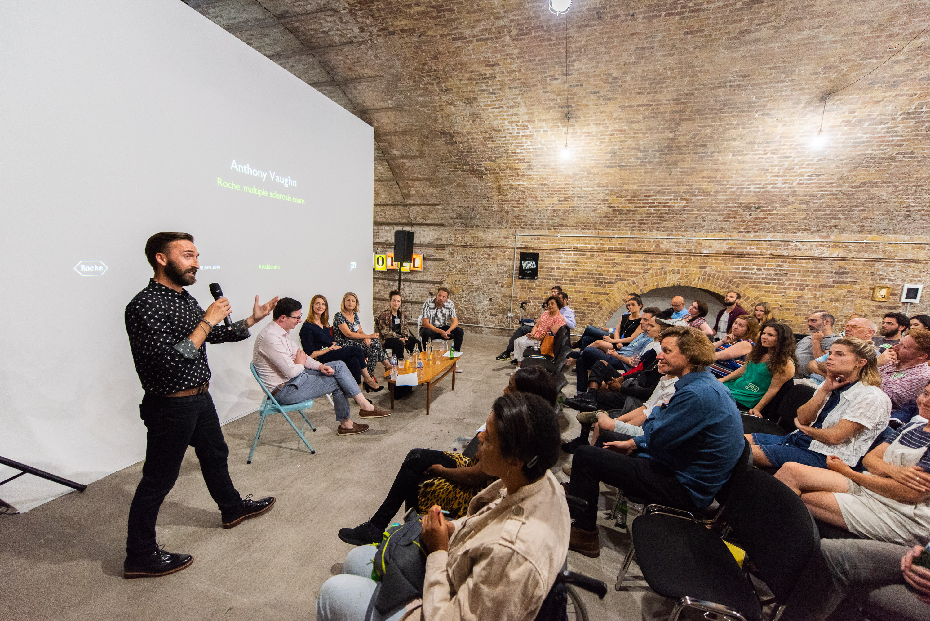 Engaging speaker in rustic Studio 1 at MOTEL for networking event.