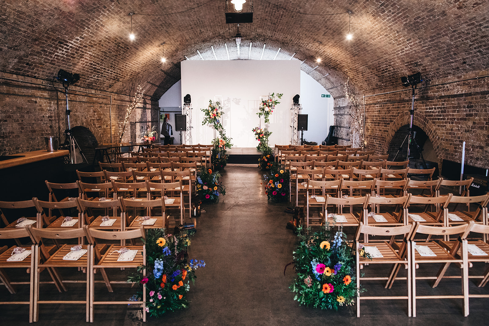 Intimate event space with arched brick interior, perfect for weddings and corporate events.