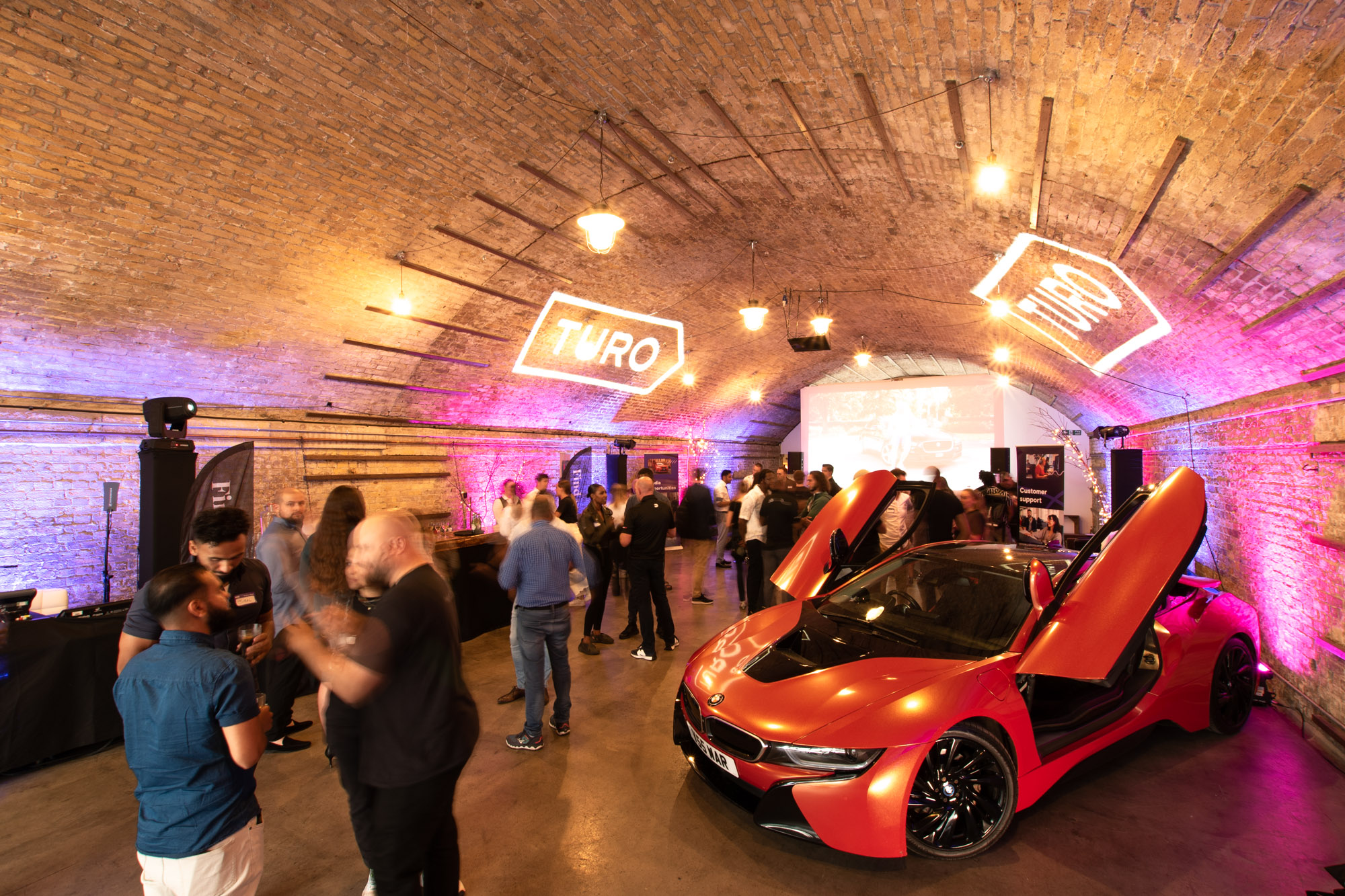 Vibrant event space with modern car, ideal for product launches and brand activations.