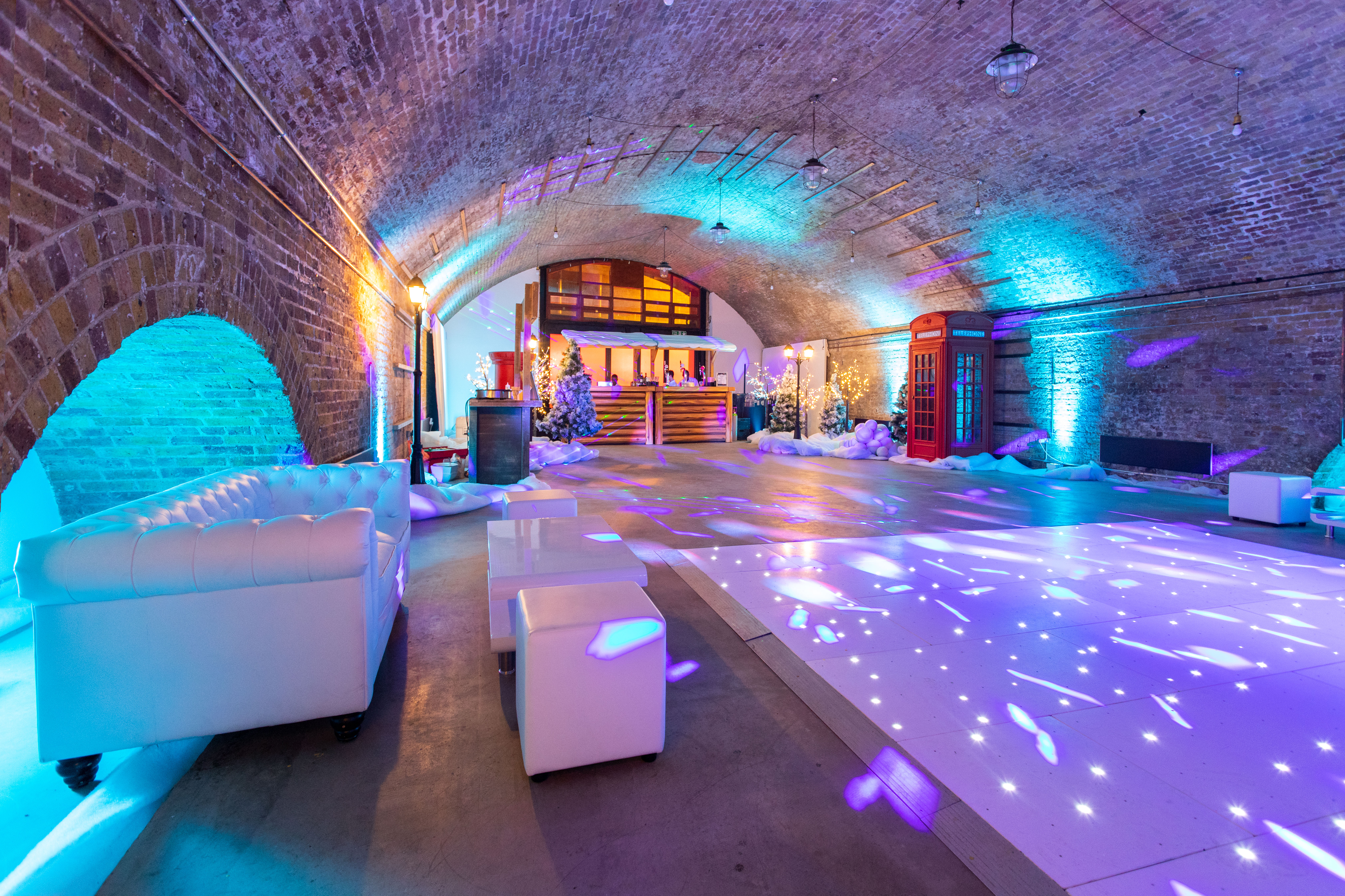 Stylish event space with arched brick ceiling, ideal for holiday parties and corporate events.