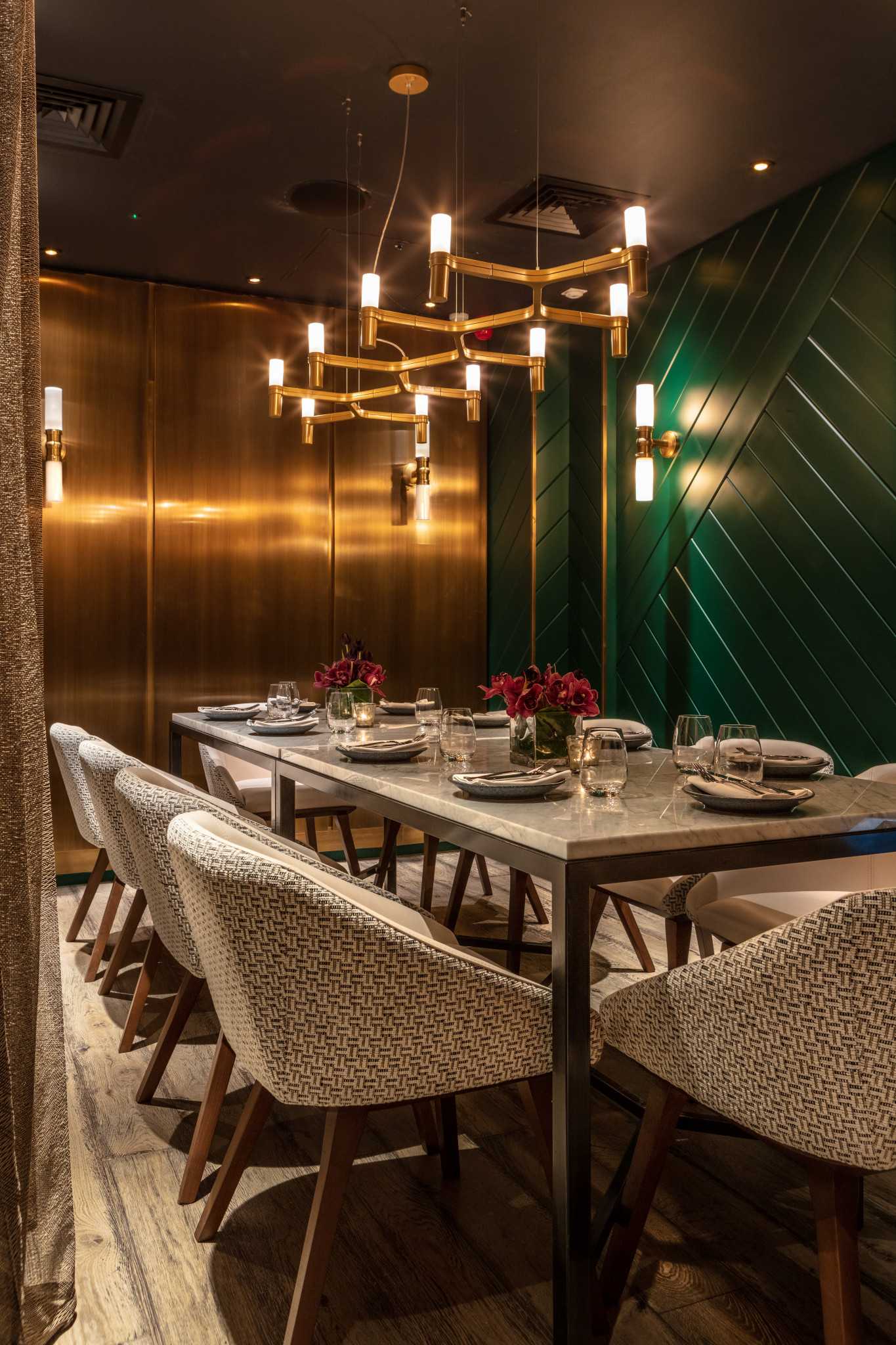 Elegant dining space with green walls for corporate dinners and private events in Farzi London.