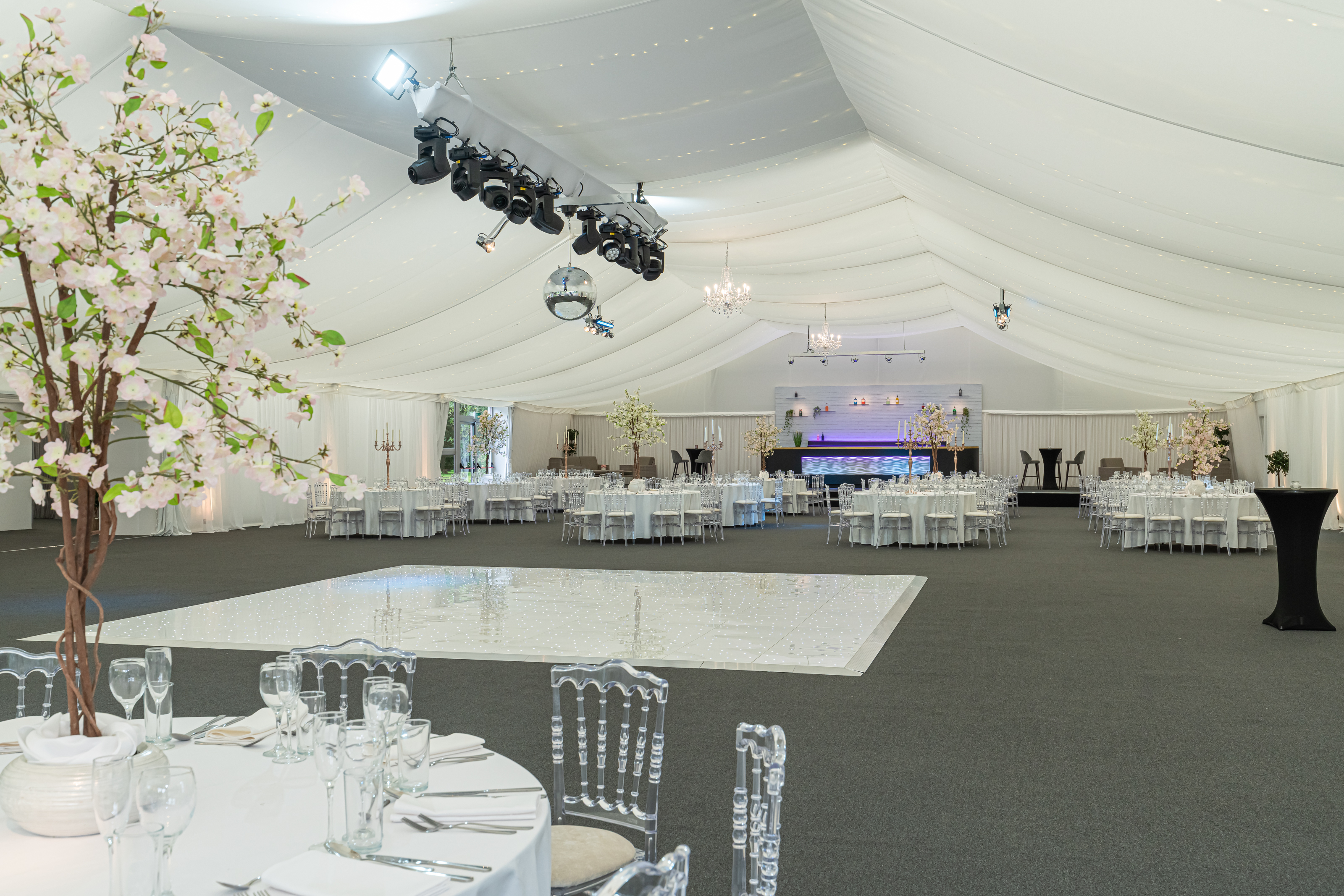 Ditton Manor House marquee with elegant dining setup for weddings and corporate events.