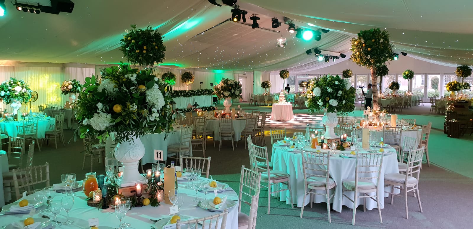 Elegant Ditton Manor Marquee with floral centerpieces for weddings and formal gatherings.