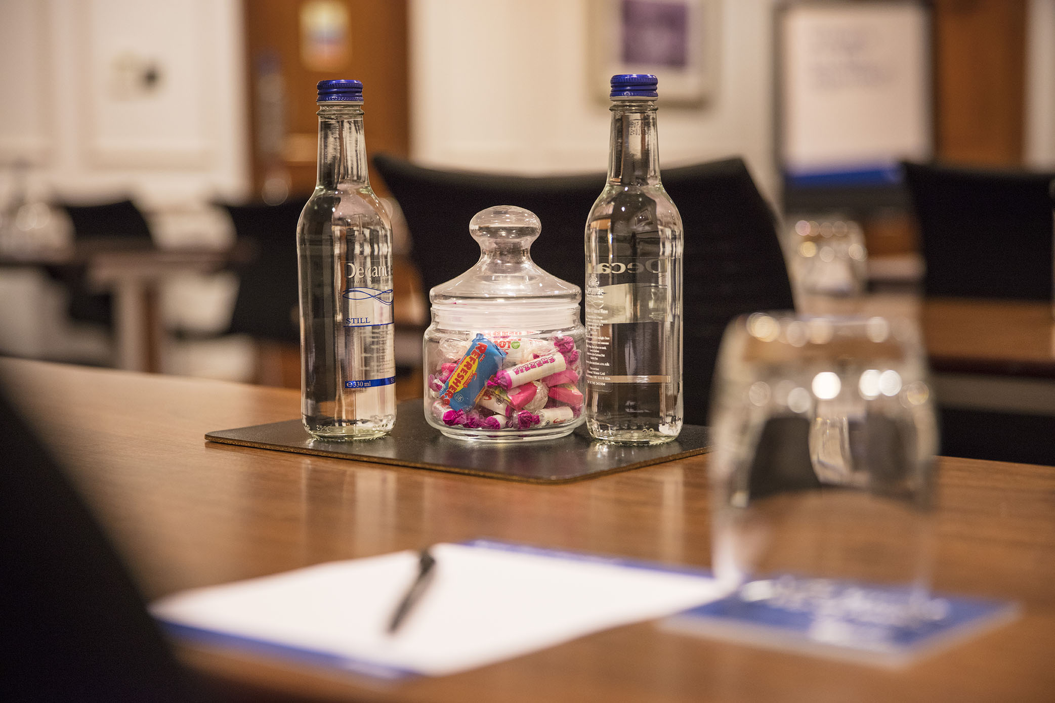 Meeting setup at Albion Thistle Holborn with water and candy for an inviting atmosphere.