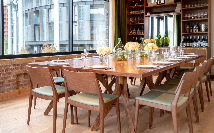Private dining room with large wooden table, ideal for corporate meetings and events.