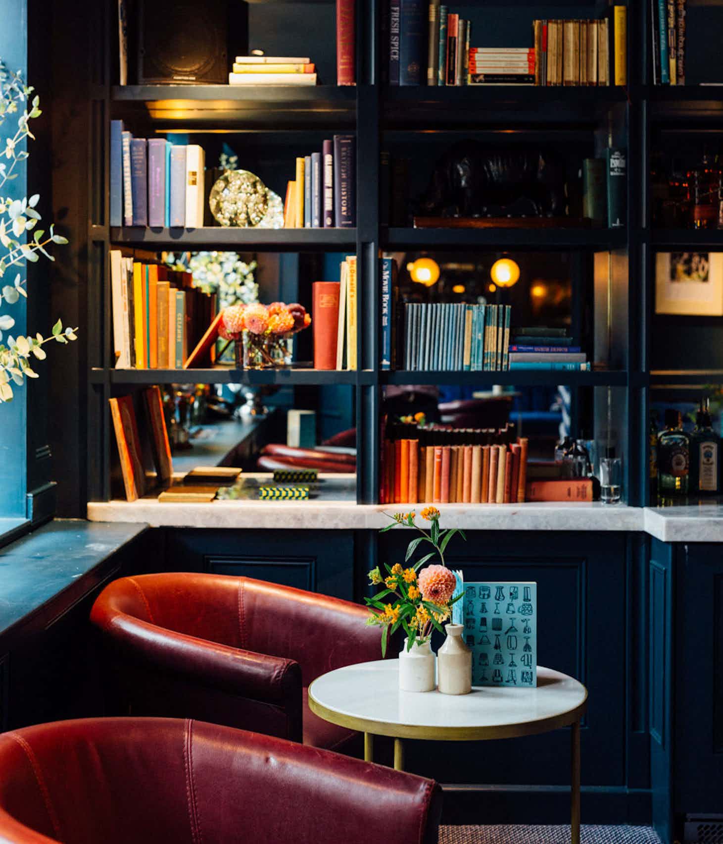 Cozy library space with elegant bookshelves for intimate meetings and networking events.