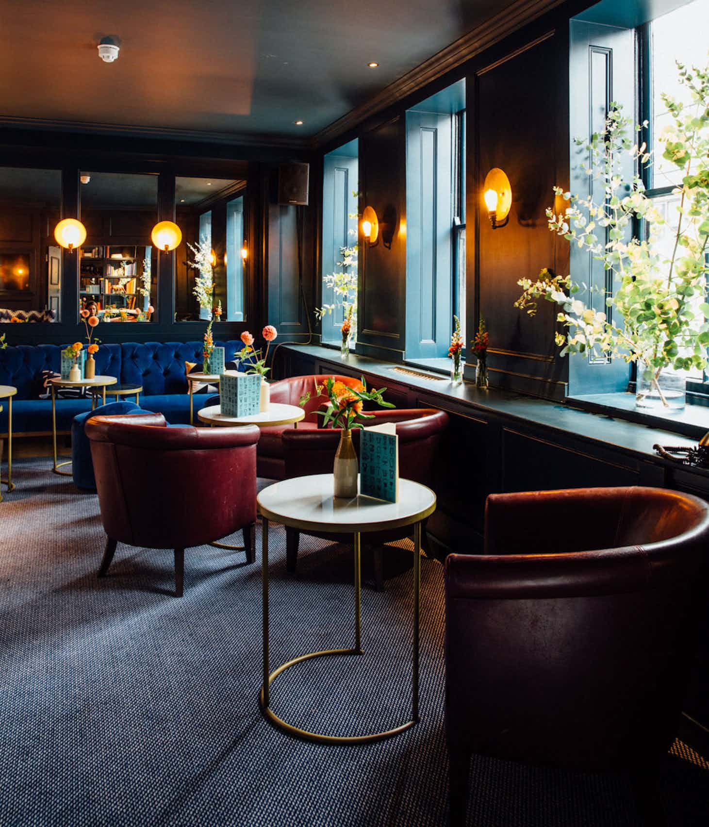 Intimate Blue Room at Quo Vadis with plush seating for networking events and gatherings.