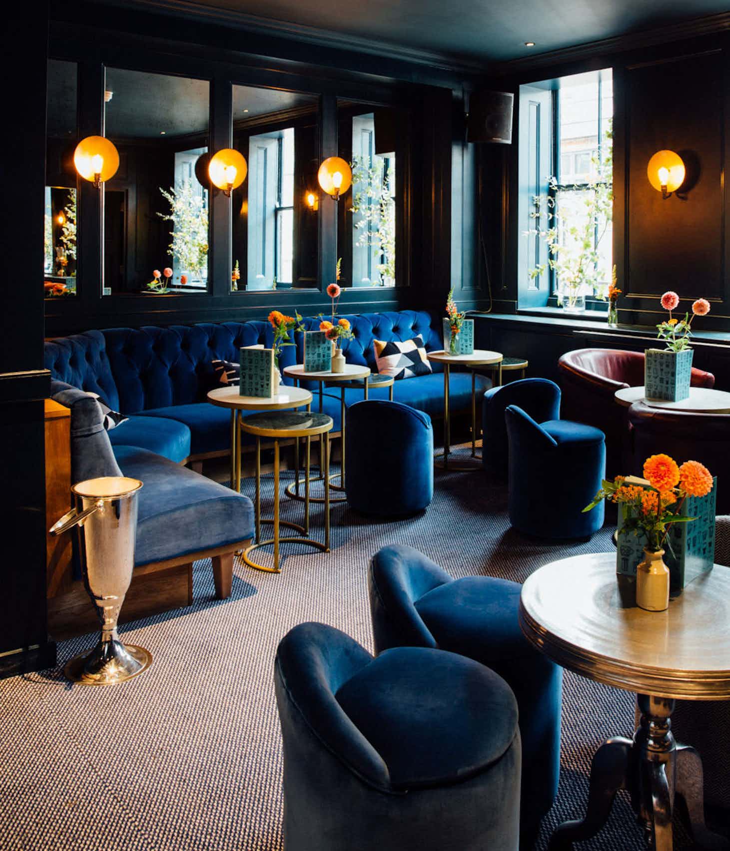 Stylish Blue Room lounge with plush seating for intimate meetings and networking events.