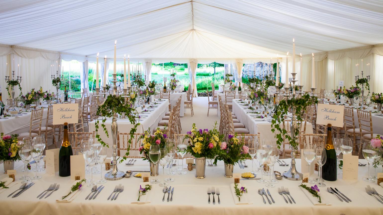 Elegant croquet lawn setup with floral centerpieces for weddings and corporate events.