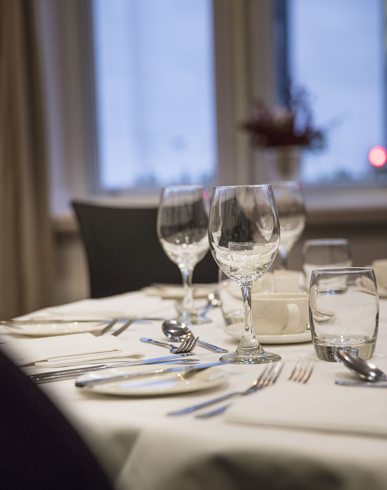 Elegant dining table setup with glassware for a formal corporate dinner event.
