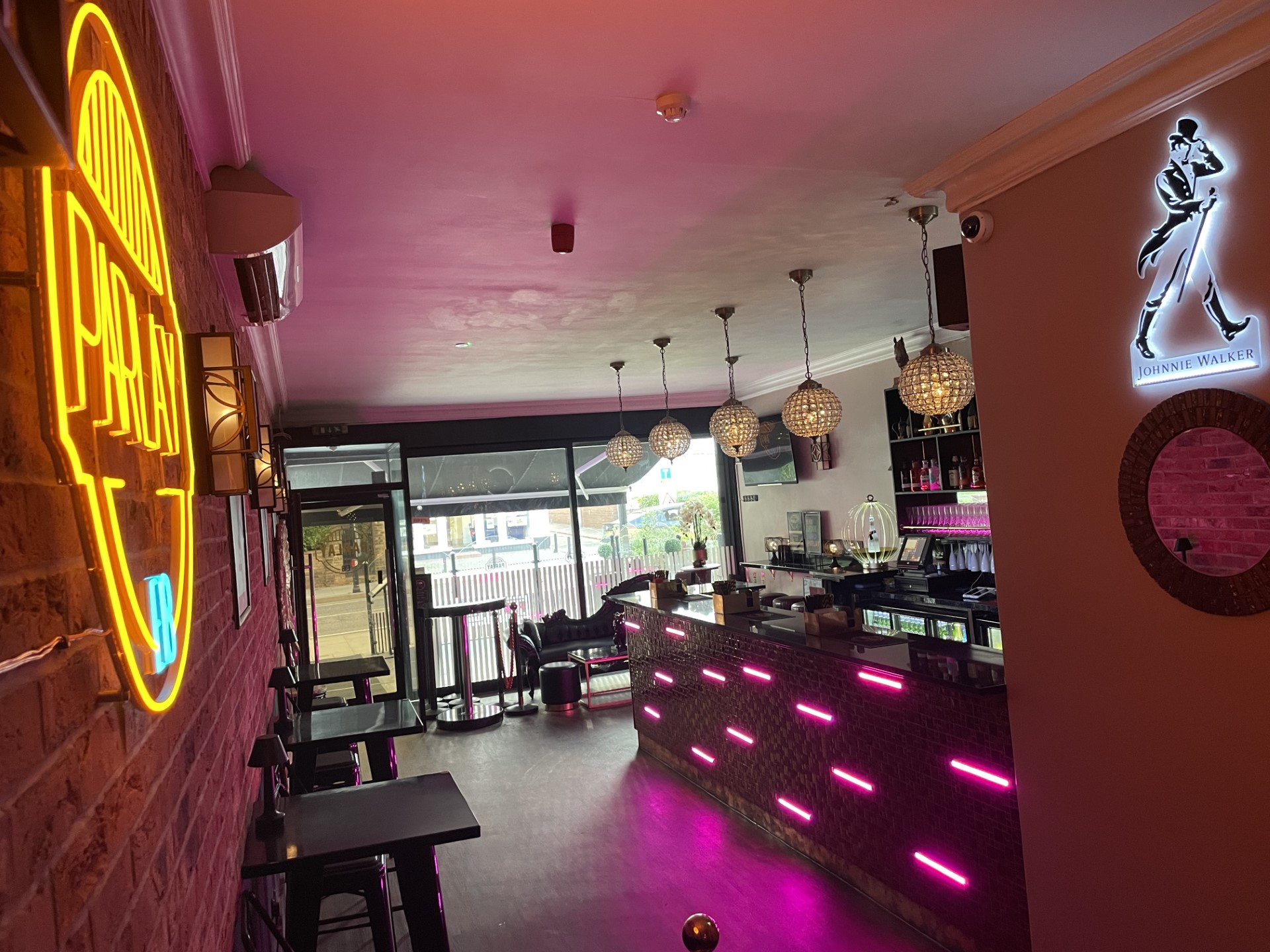Modern Parlay E18 Bar & Grill with vibrant neon lighting, perfect for events and gatherings.