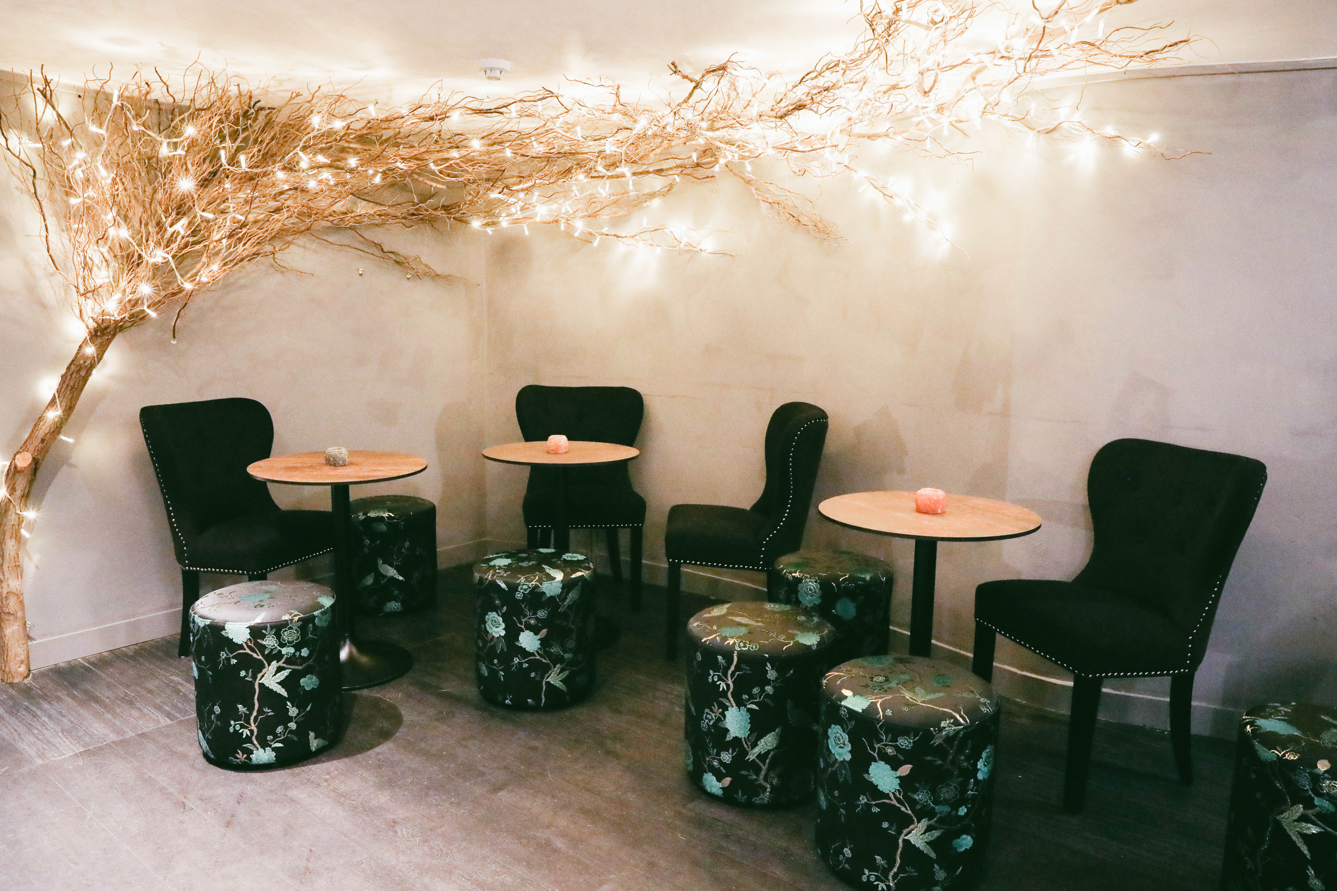 Cozy Sandy's Piano Bar with fairy lights, ideal for intimate gatherings and workshops.