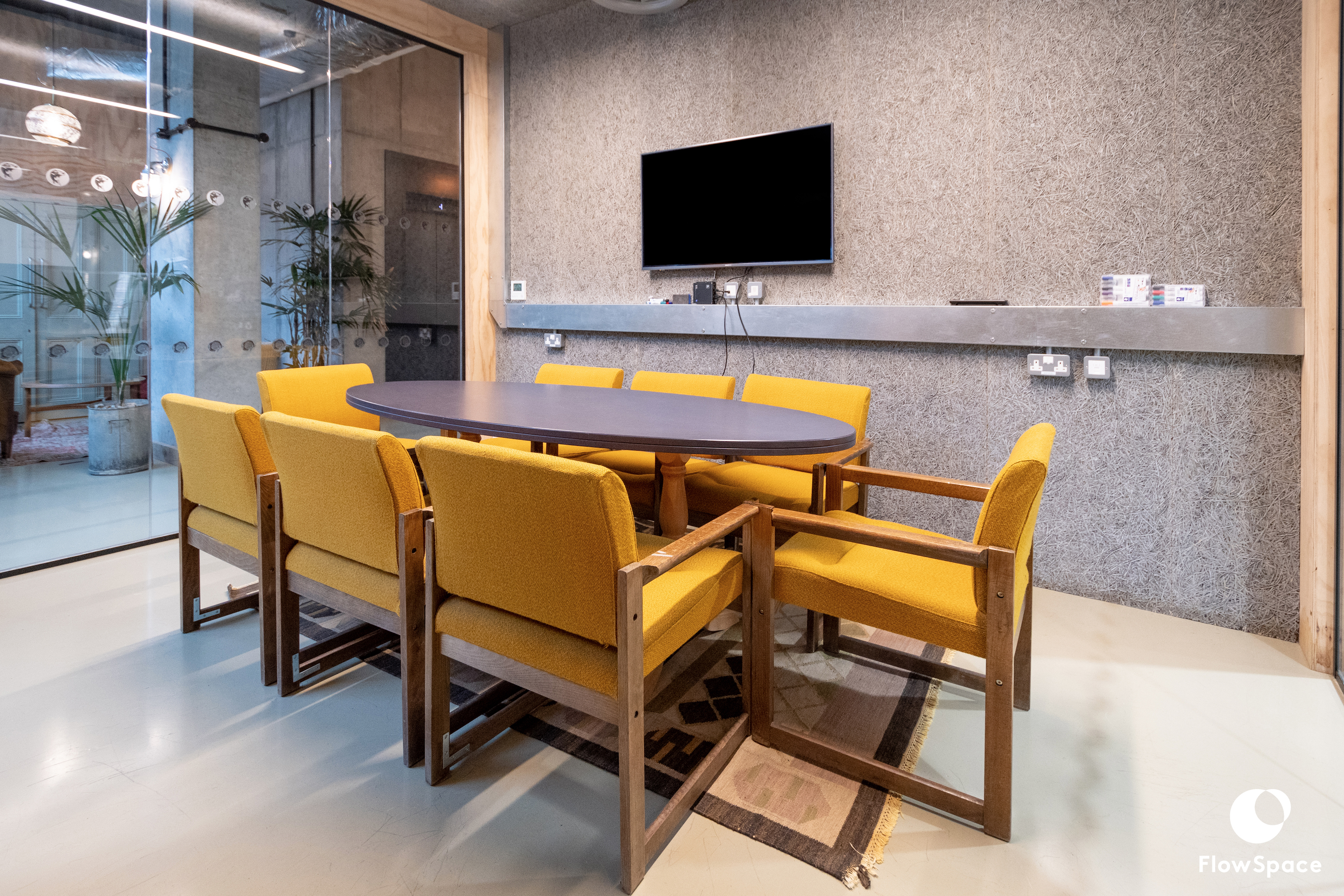 Modern Mentmore Meeting Room with oval table and yellow chairs for collaborative sessions.