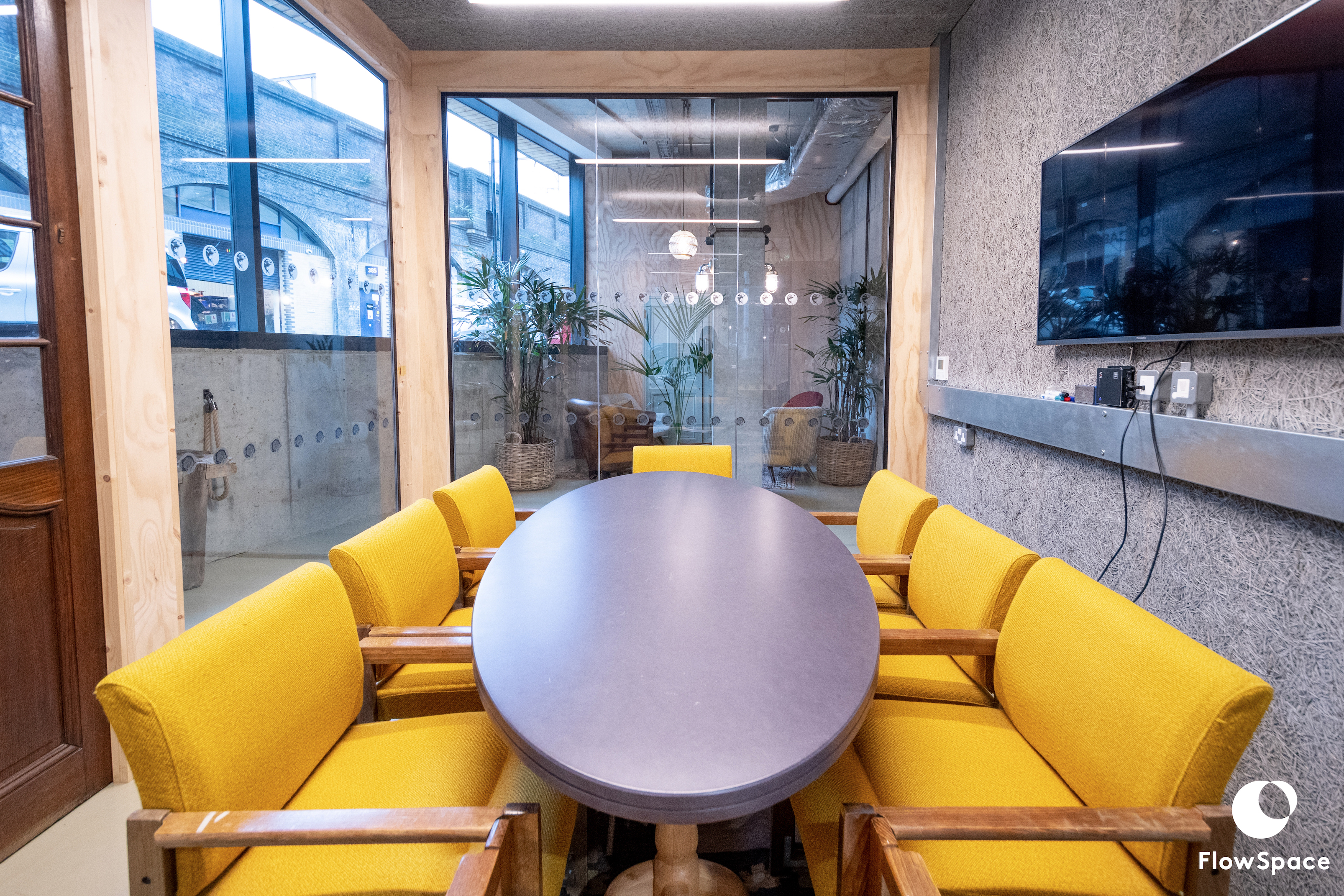 Modern Mentmore Meeting Room with oval table and yellow chairs, perfect for team brainstorming.