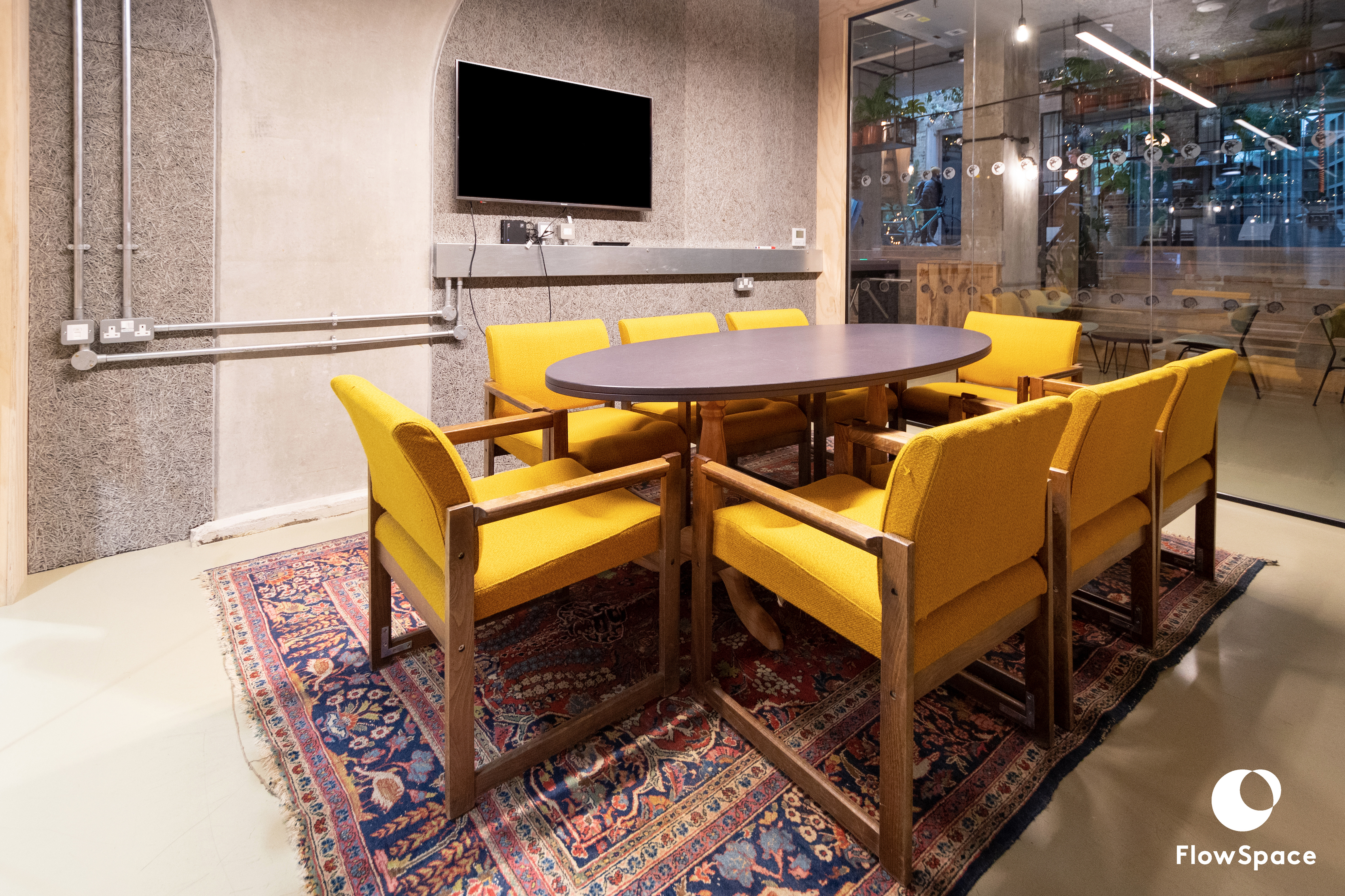 Modern Mentmore Meeting Room with round table and yellow chairs for collaborative sessions.
