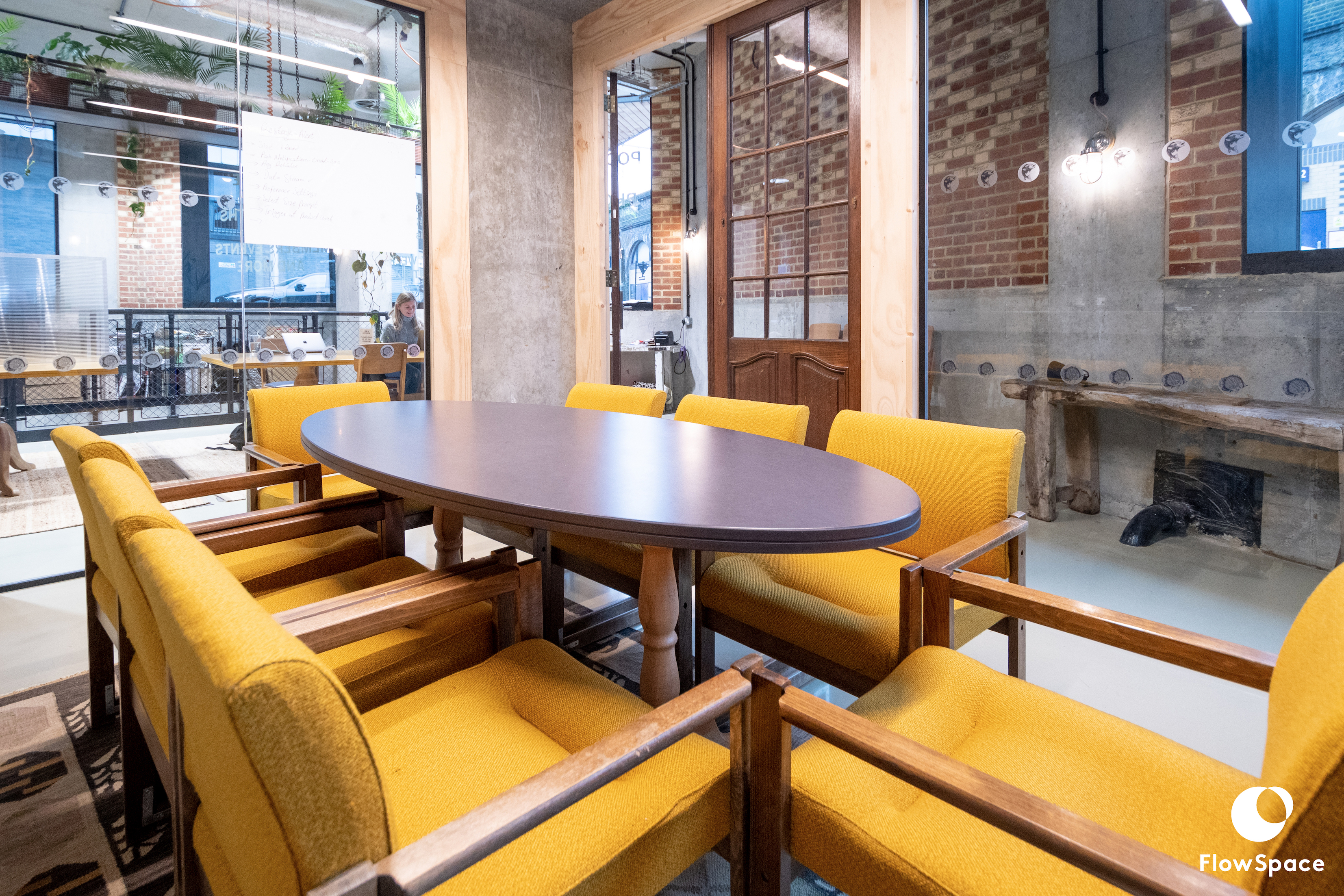 Modern Mentmore Meeting Room with oval table and yellow chairs, perfect for team meetings.