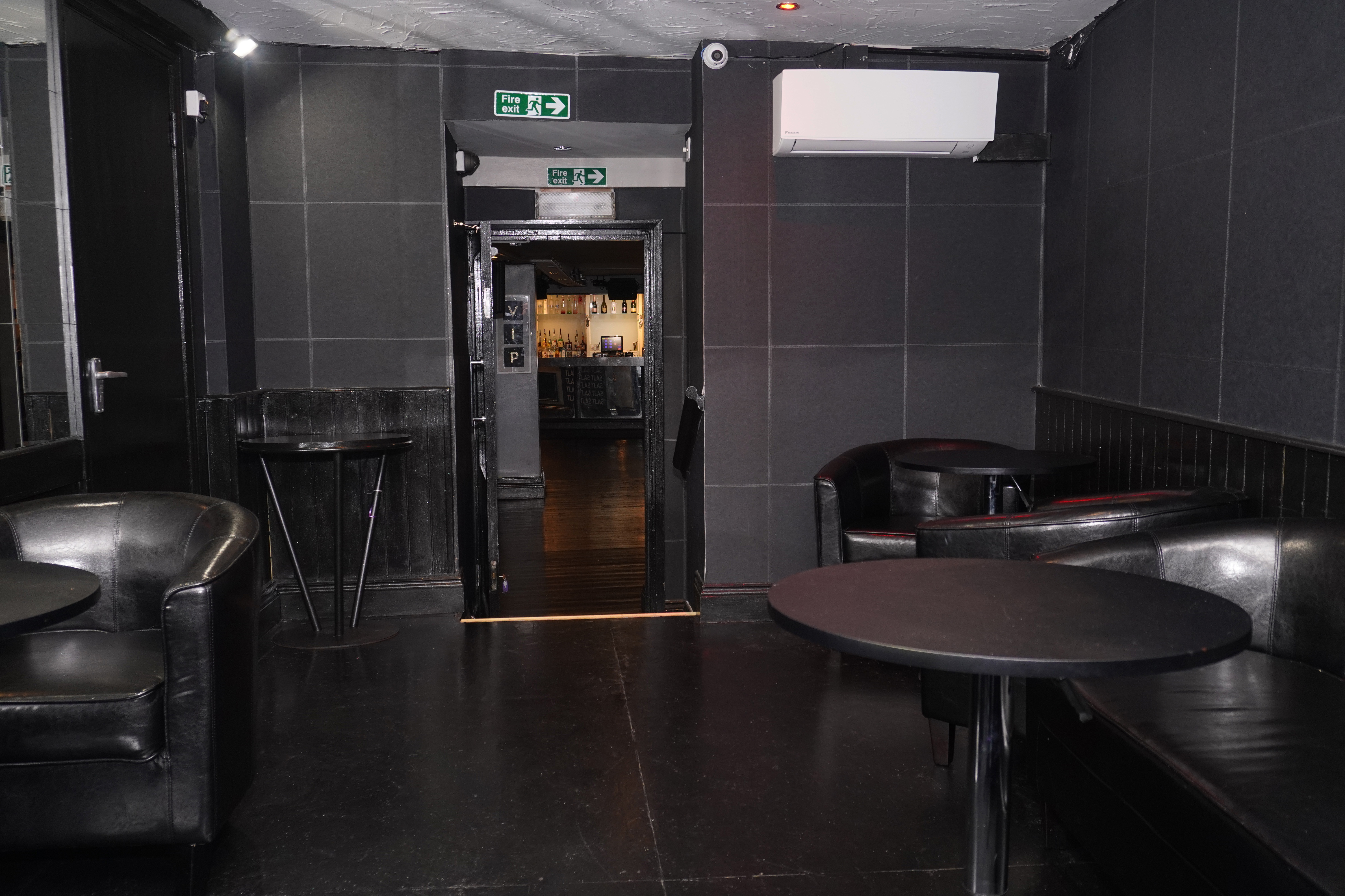 Modern event space in West Hampstead with black walls, ideal for networking and gatherings.
