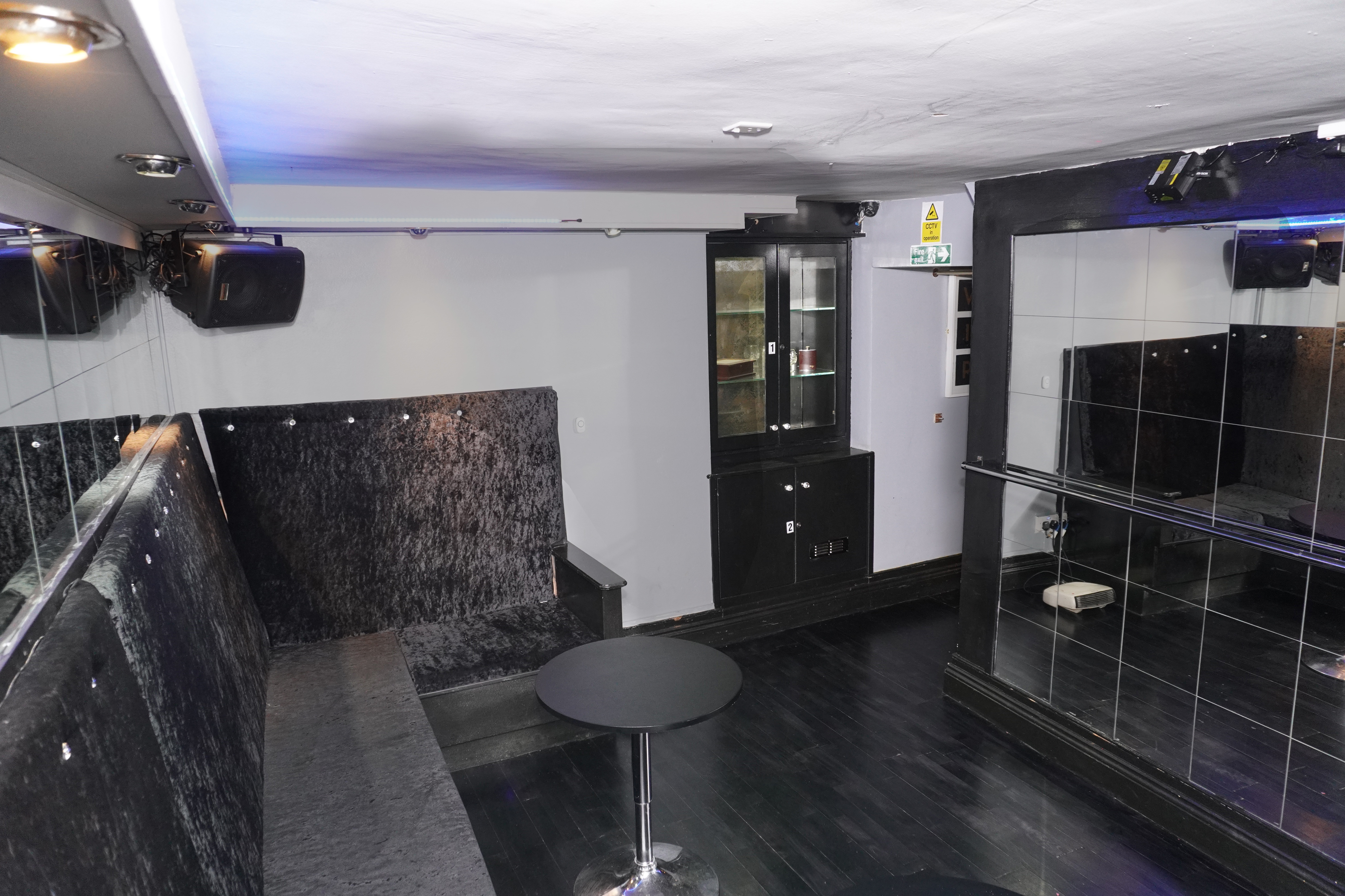 Modern event space in West Hampstead with mirrored walls, ideal for corporate gatherings.