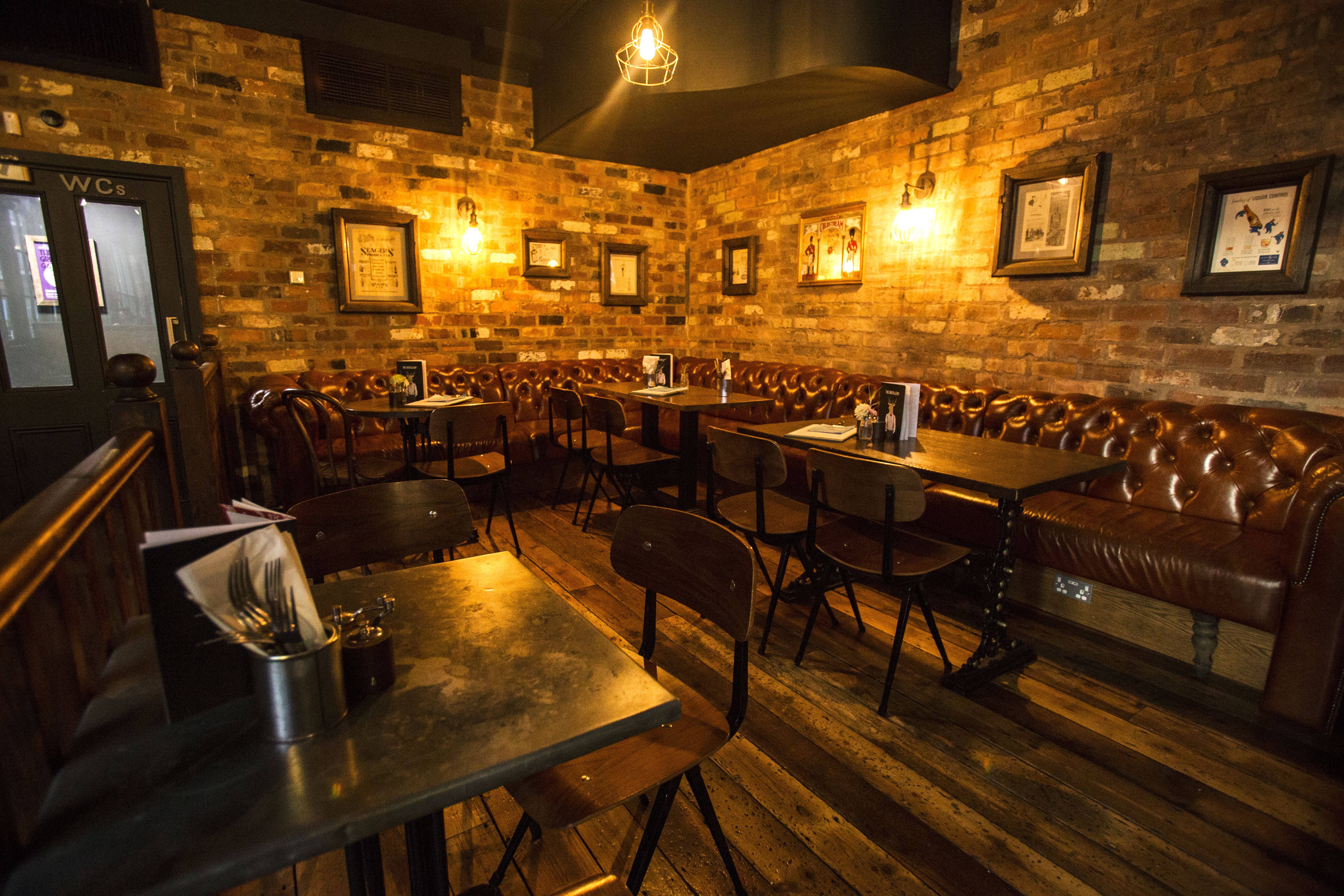 Cozy Gin Snug venue with leather seating for intimate gatherings in Birmingham.