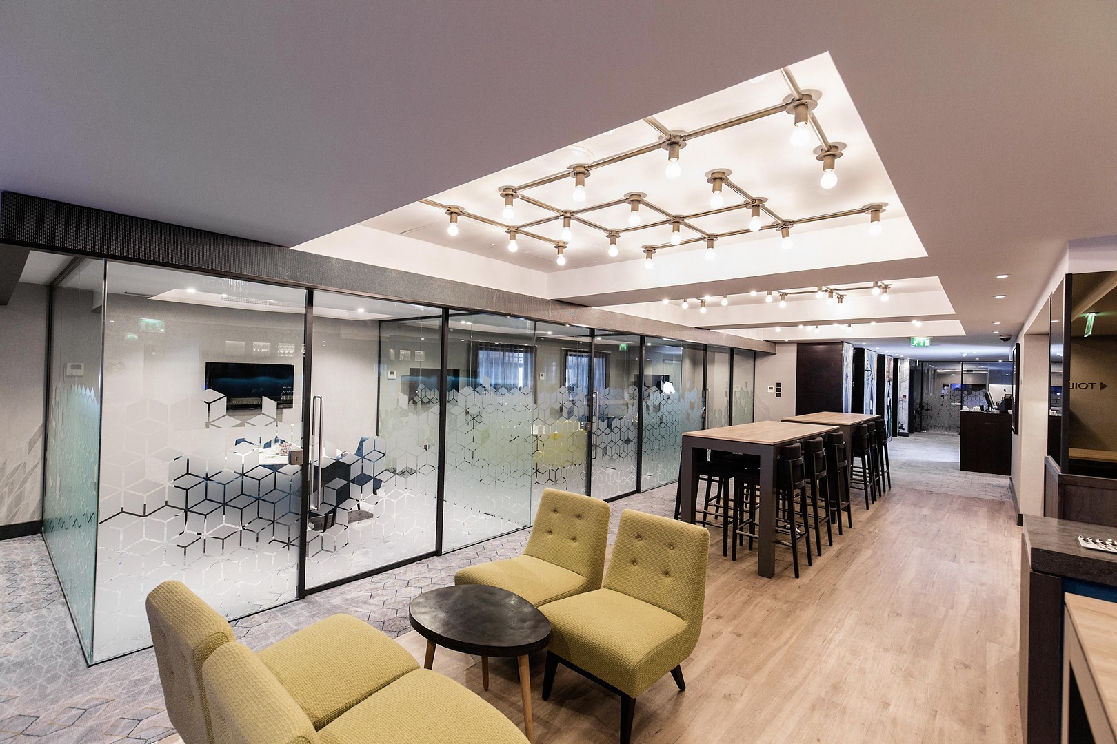 Modern meeting space in Malmaison Birmingham with glass-walled rooms for collaboration.