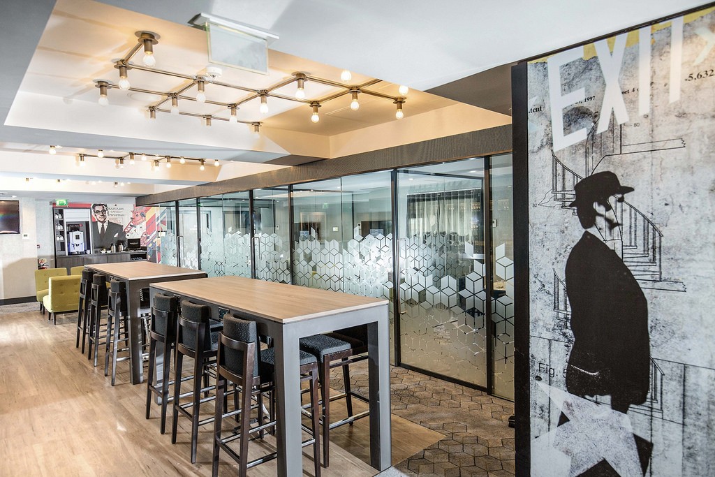 Modern meeting space in Malmaison Birmingham with glass-walled conference room.