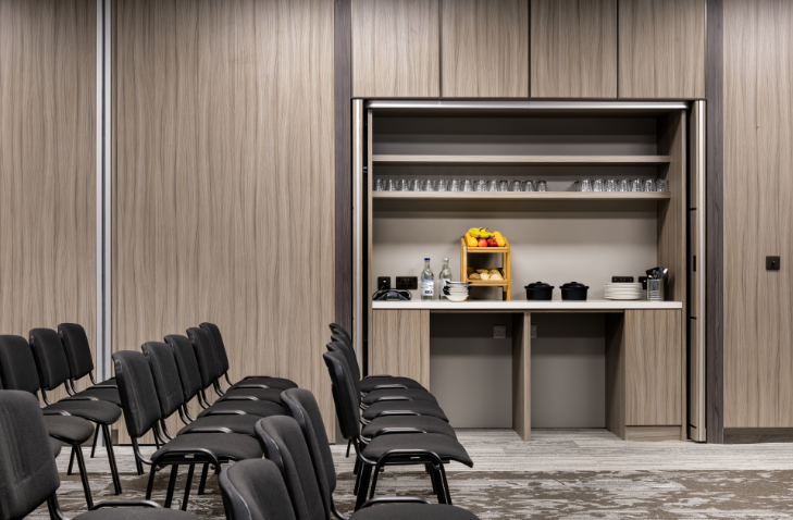 Hidden refreshment station in AC Marriott Manchester meeting room for corporate event setup.