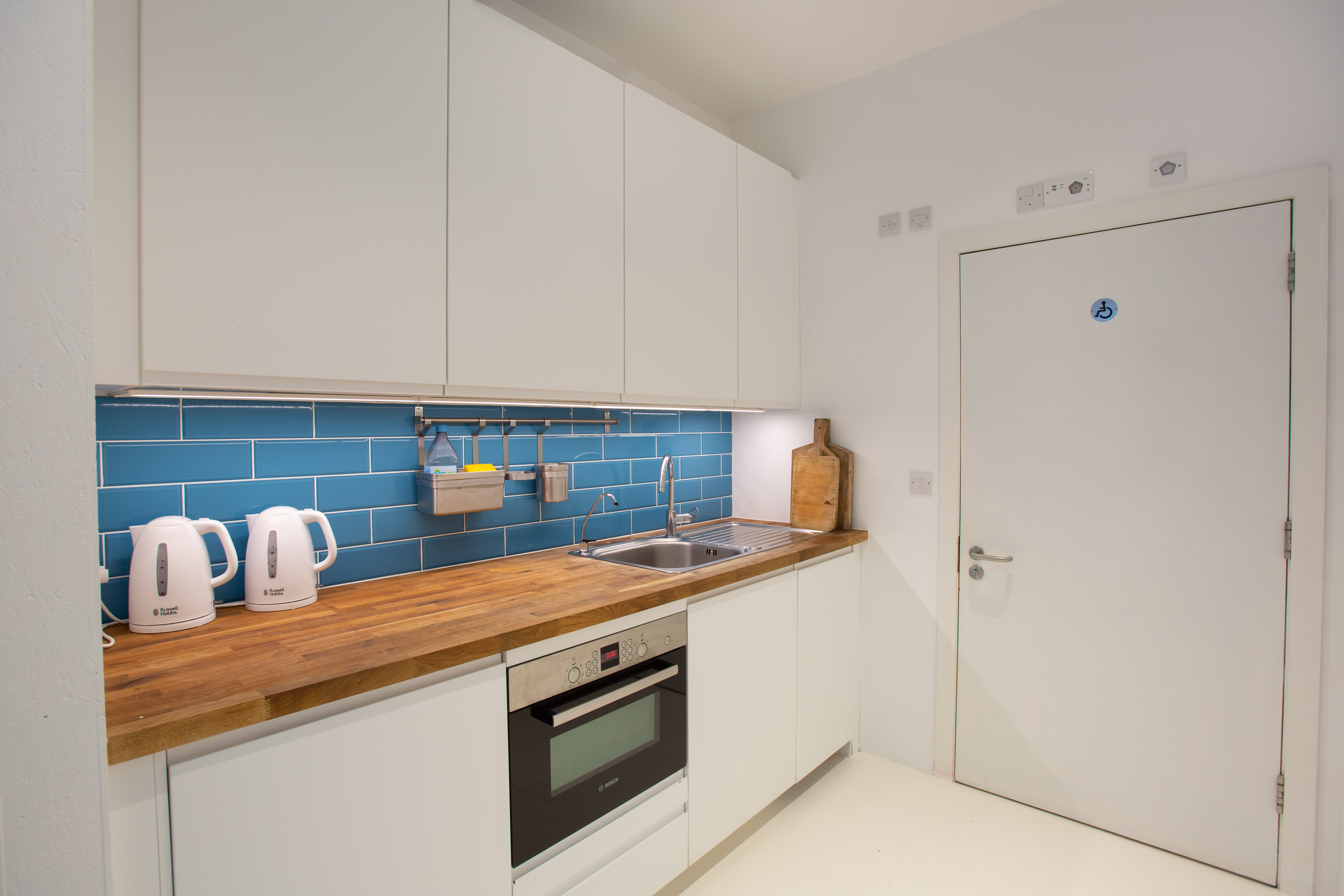 Modern kitchenette in Studio 52, featuring sleek cabinetry for events and meetings.