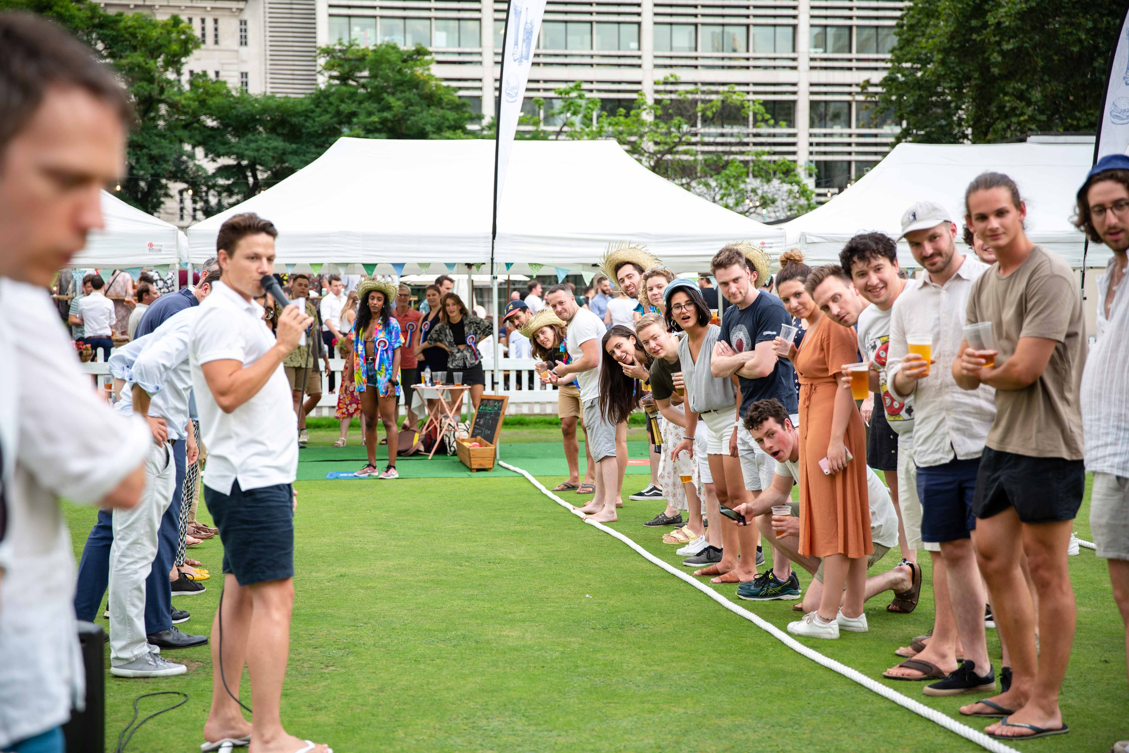 Lively outdoor event at Festibowl with engaged attendees and tents for networking.