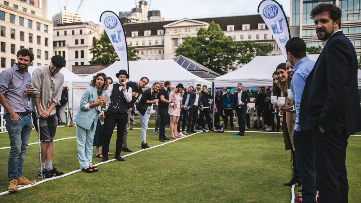 Vibrant outdoor event at Festibowl with tents, flags, and a diverse crowd for networking.