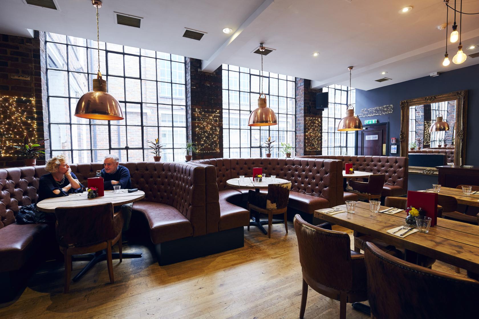 Stylish restaurant interior with cozy booths, perfect for intimate meetings and events.