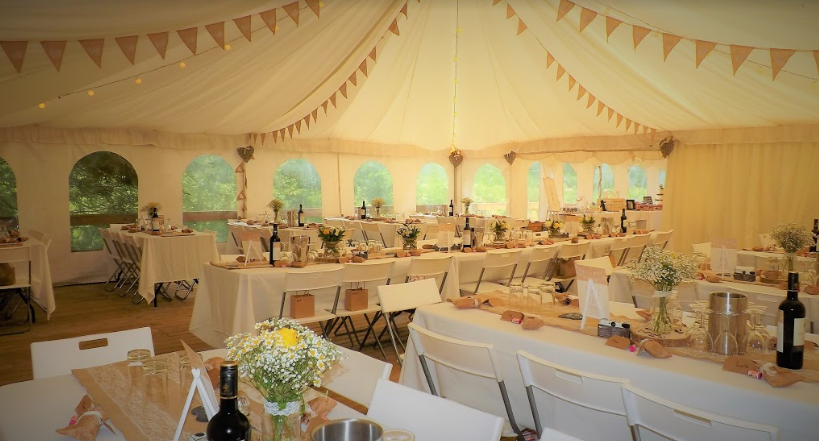 Tented wedding venue at Beeses Riverside Bar with elegant decor and soft lighting.