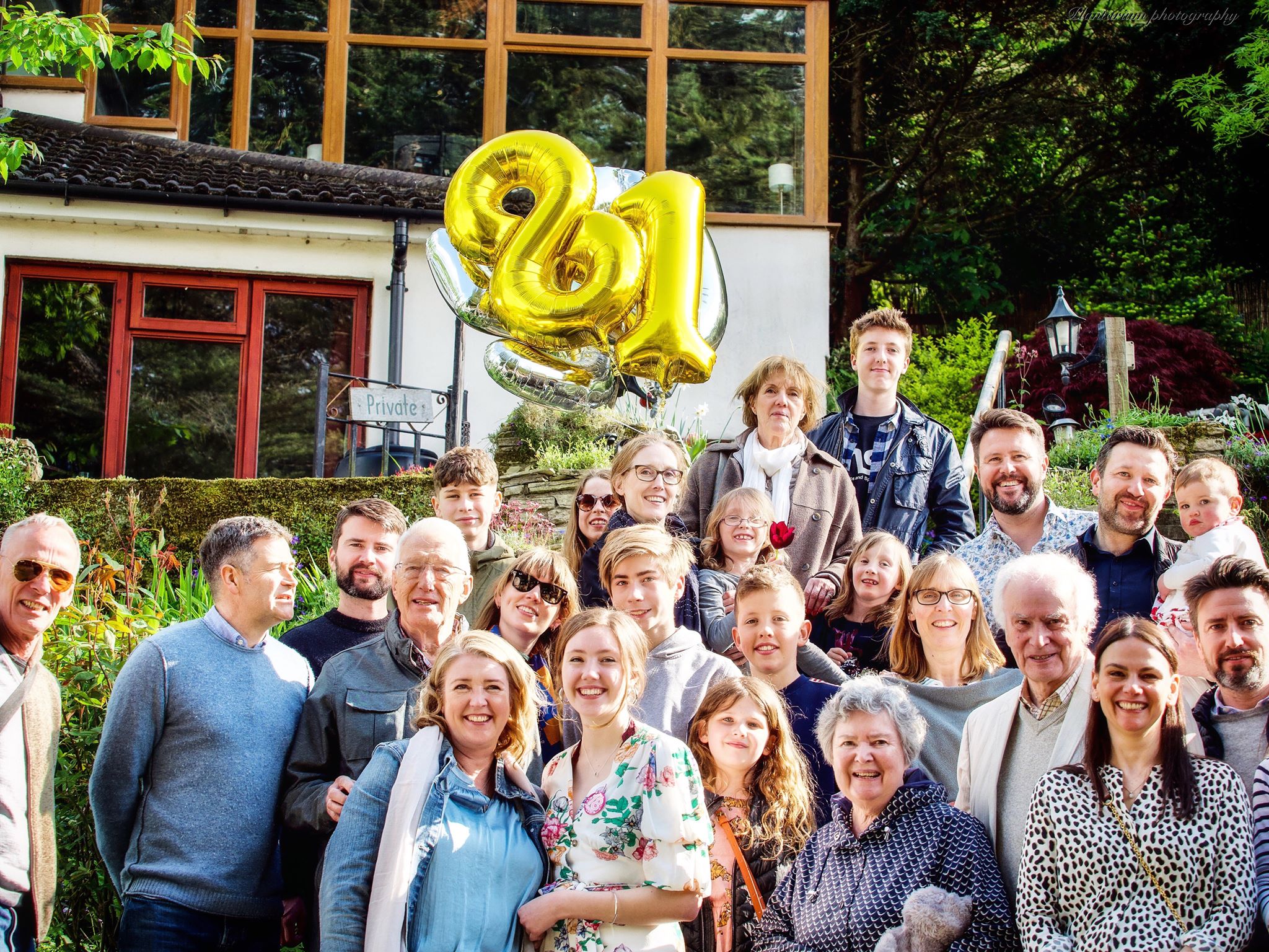 Vibrant birthday celebration at Beeses Riverside Bar with golden "81" balloons.