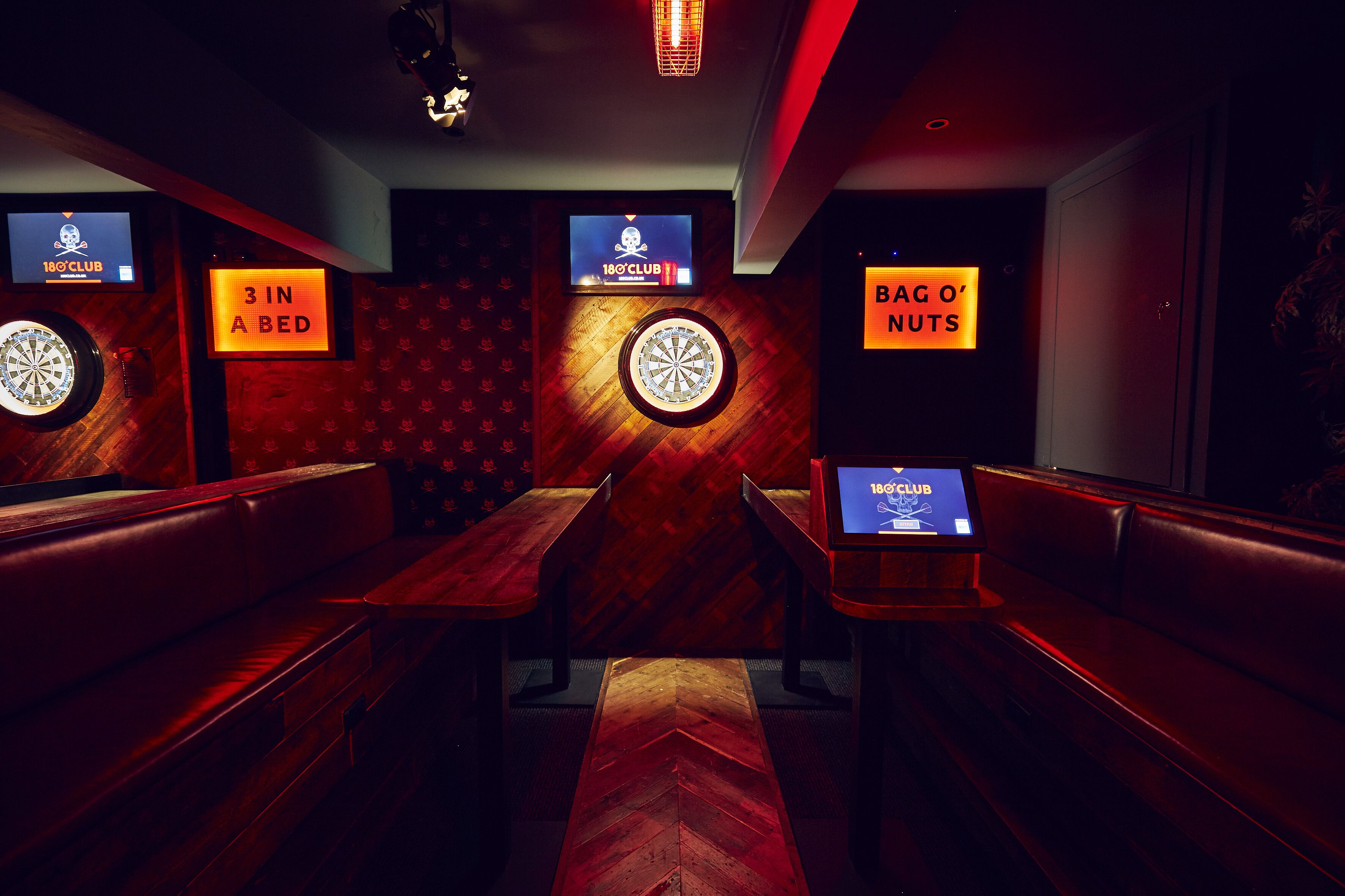 Stylish darts event space with cozy seating for team-building and networking activities.