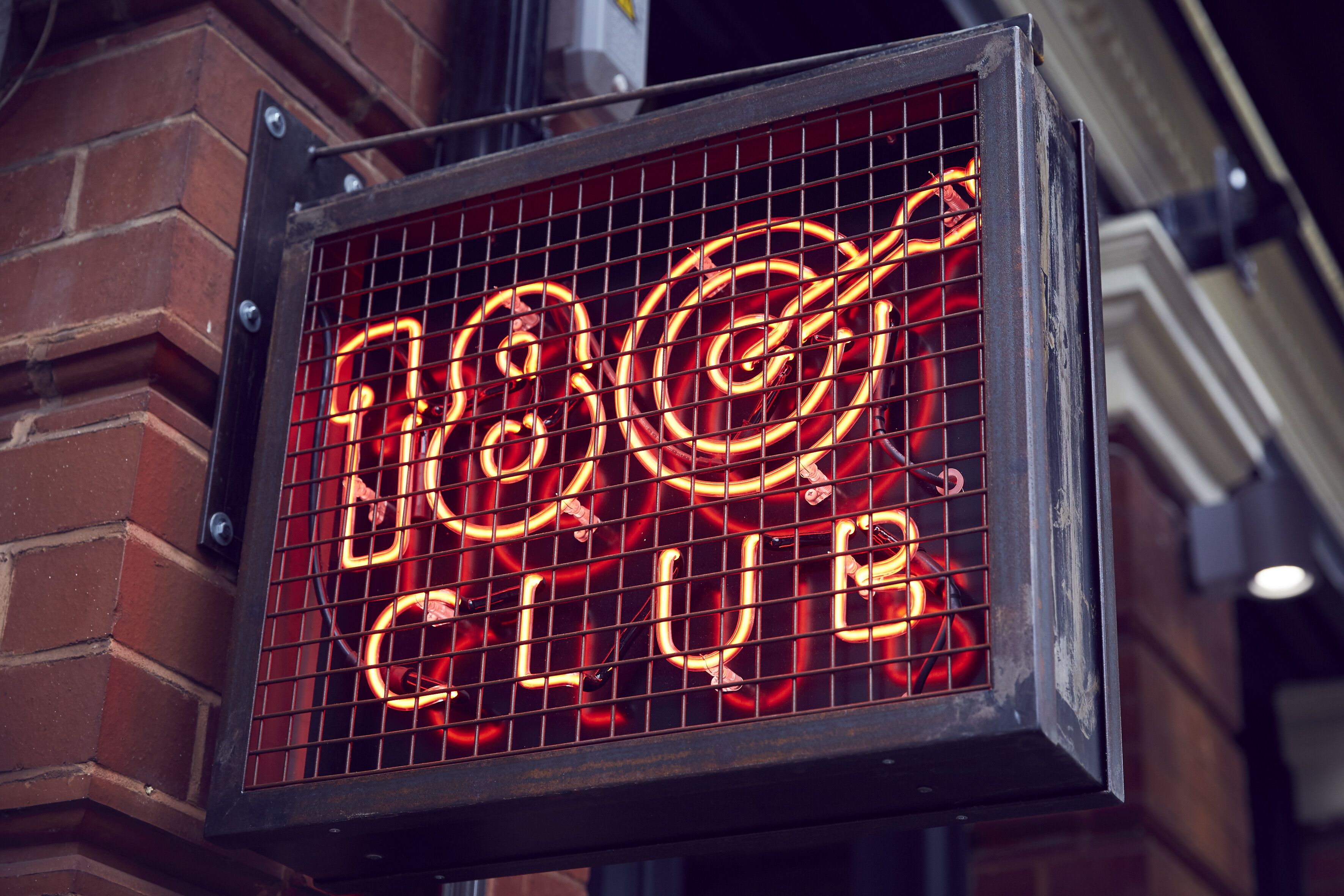 Vibrant neon "18 Club" sign at Darts Space, ideal for events and gatherings.
