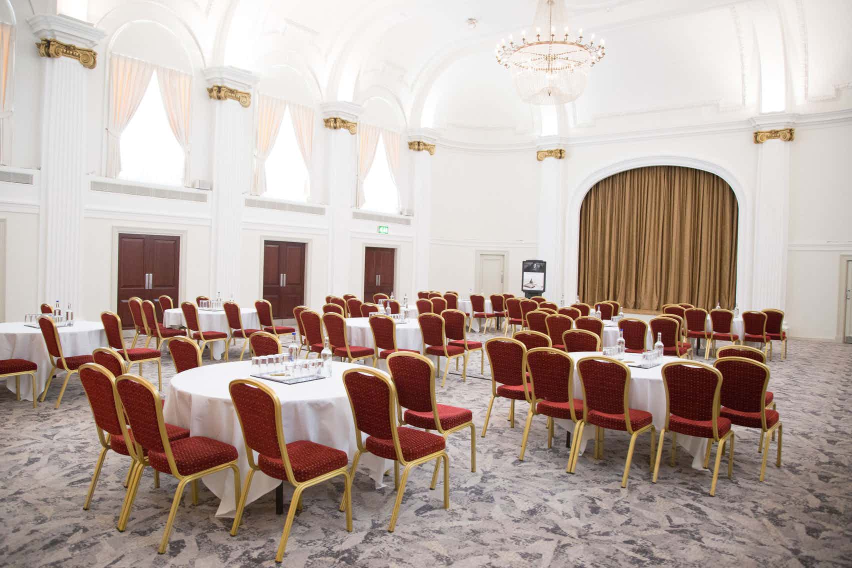 Ballroom at Mercure Grand Bristol with round tables, ideal for conferences and banquets.