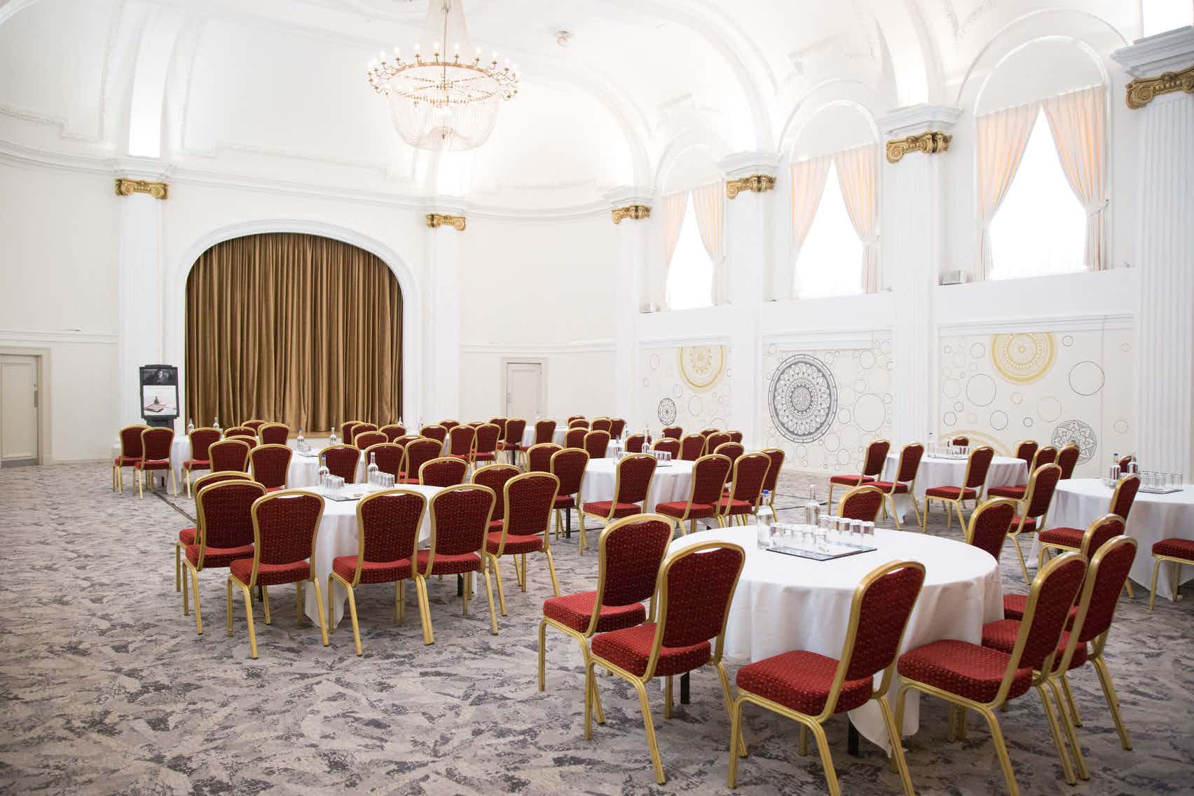 Ballroom at Mercure Grand Bristol with elegant round tables for conferences and gatherings.