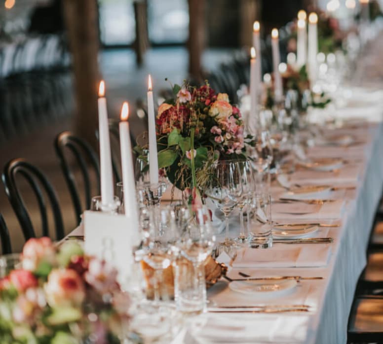 Elegant long-table banquet setup with floral decor for upscale wedding gala at JA Mar Hall.