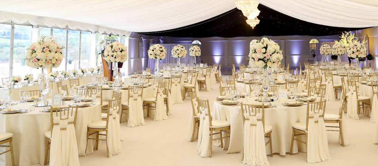 Elegant Garden Pavilion with floral centerpieces, perfect for weddings and upscale events.